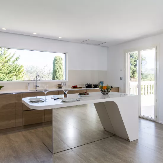 A contemporary, light-filled HIMACS kitchen with a mountain view