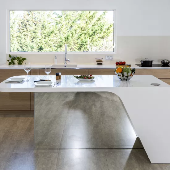 A contemporary, light-filled HIMACS kitchen with a mountain view