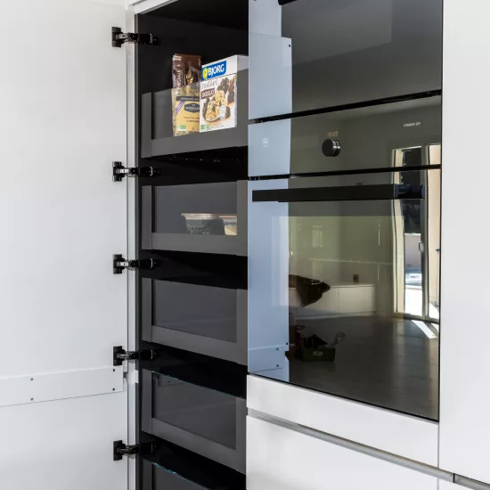 A contemporary, light-filled HIMACS kitchen with a mountain view