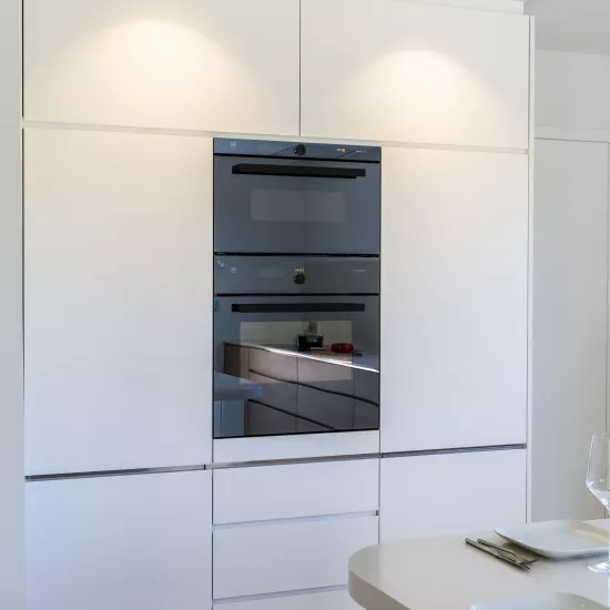 A contemporary, light-filled HIMACS kitchen with a mountain view