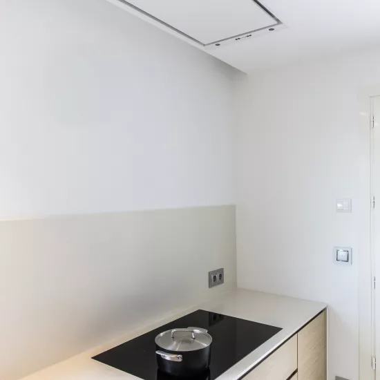 A contemporary, light-filled HIMACS kitchen with a mountain view