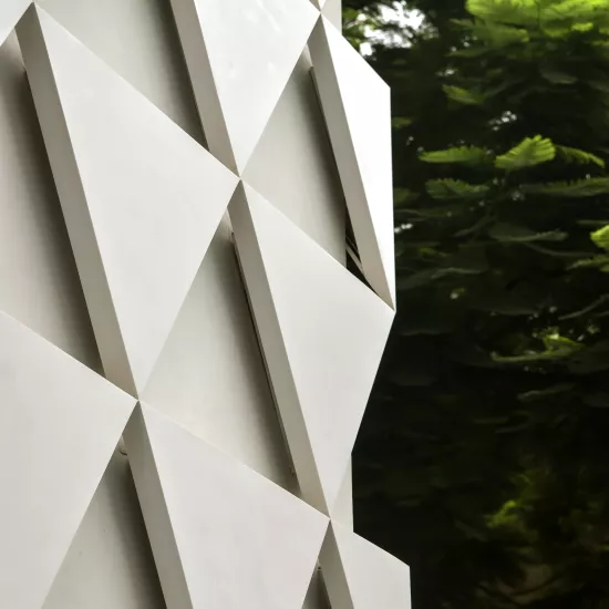 A sculptural, geometric façade made of HIMACS for JK House