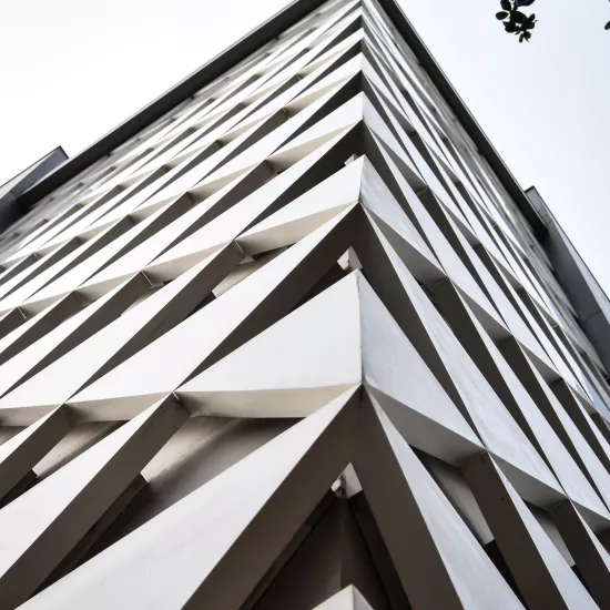 A sculptural, geometric façade made of HIMACS for JK House