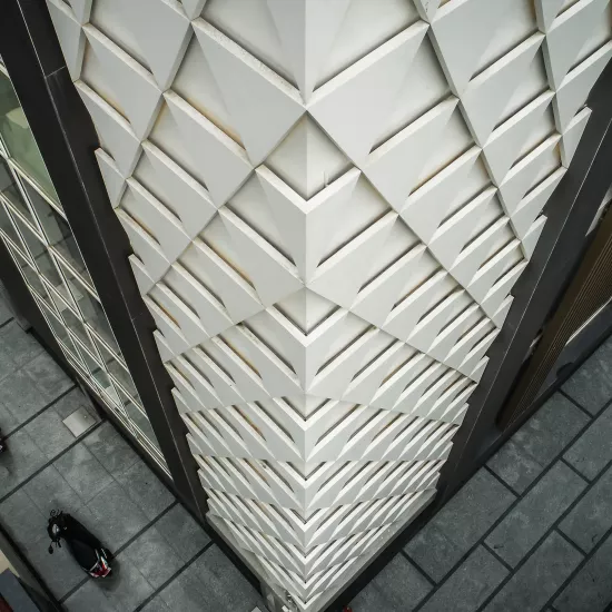 A sculptural, geometric façade made of HIMACS for JK House