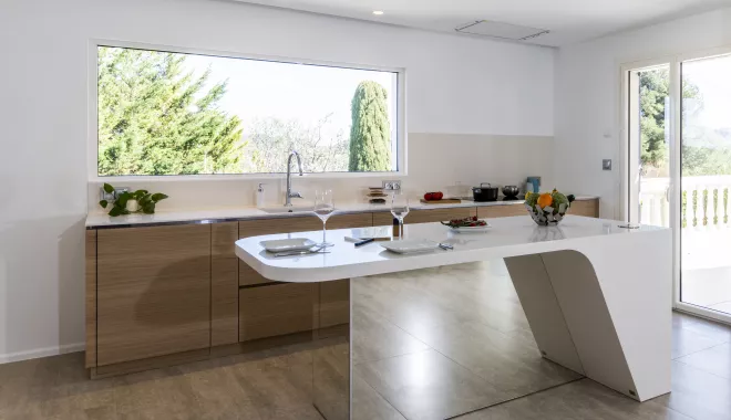 A contemporary, light-filled HIMACS kitchen with a mountain view