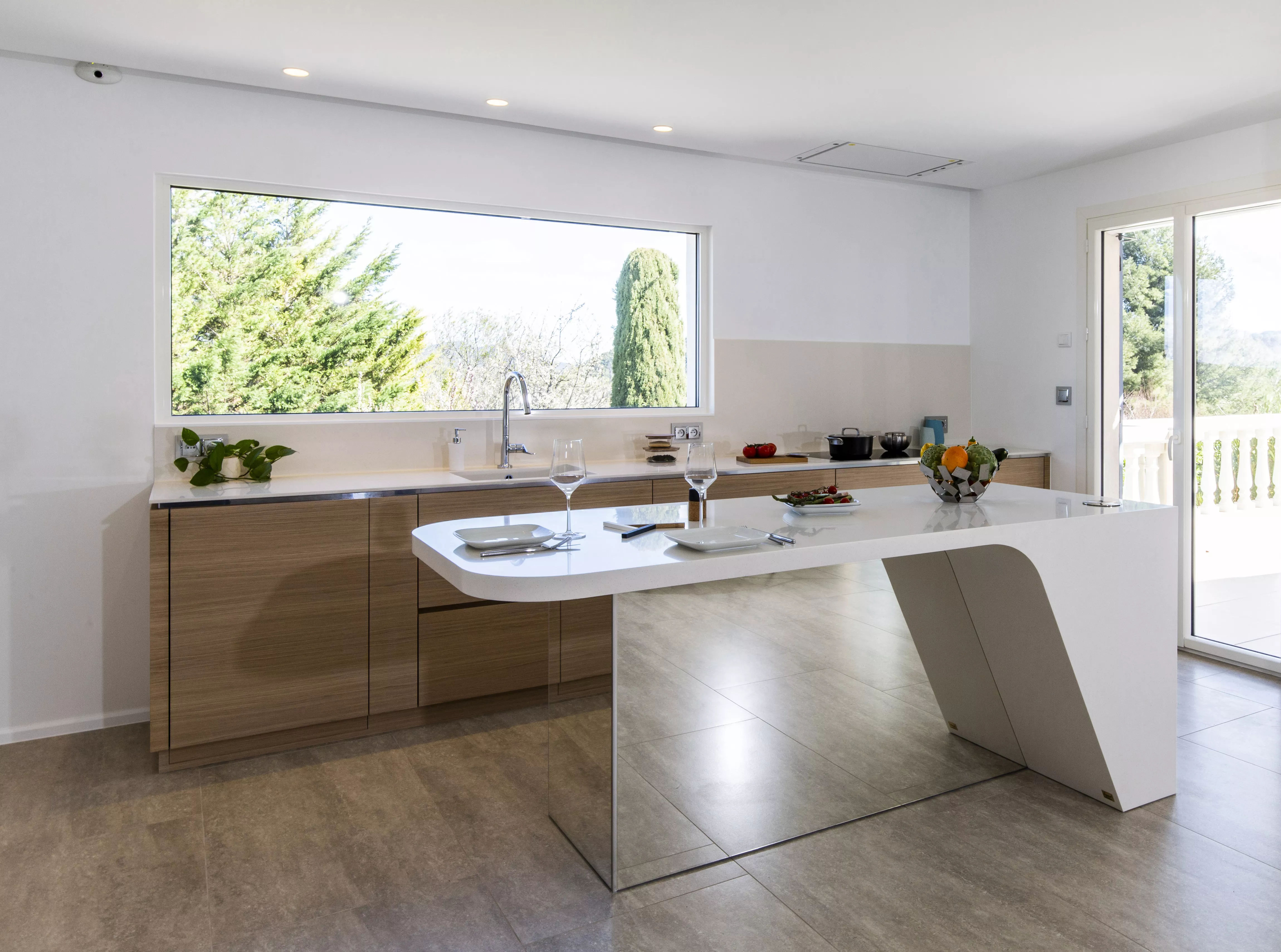 A contemporary, light-filled HIMACS kitchen with a mountain view