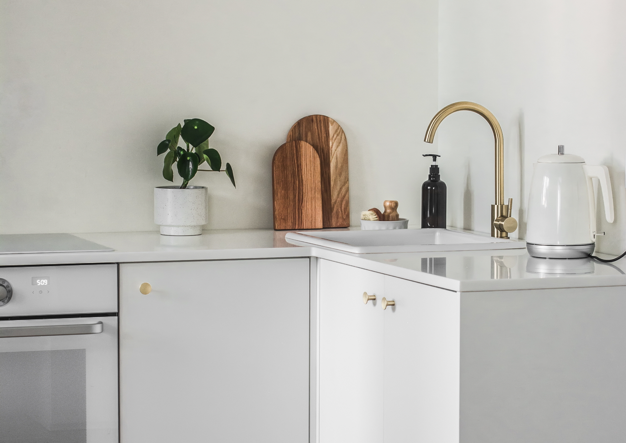 If you want a white kitchen, opt for all-white furniture to achieve a unified look.