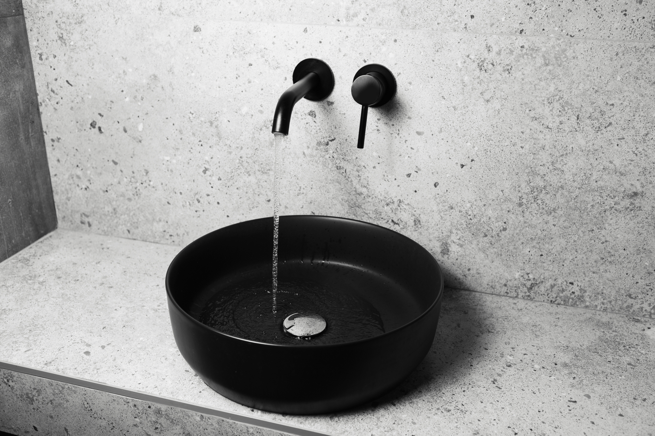 Wall-mounted faucets are the latest trend in minimalist bathroom design.