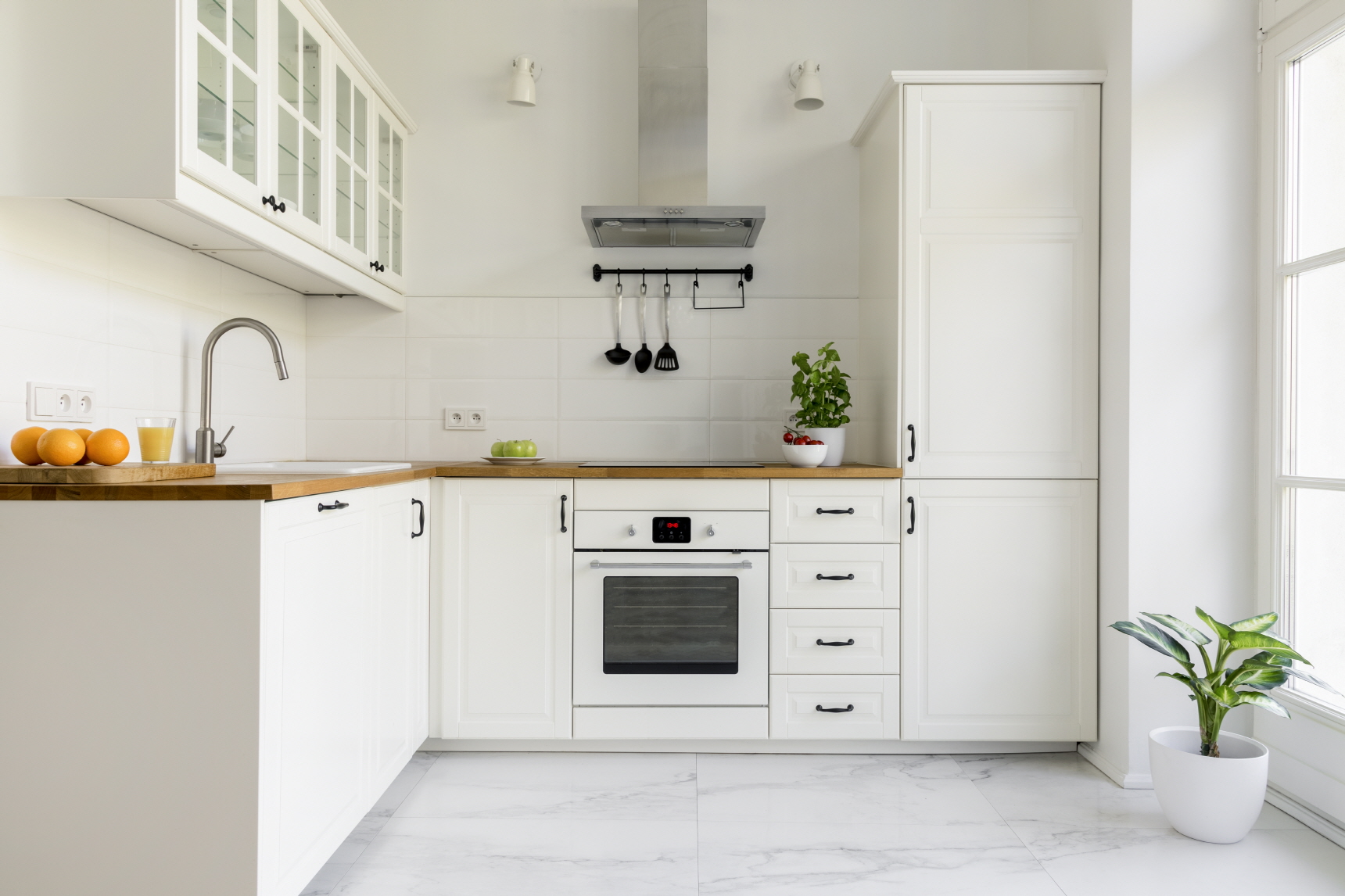 Keeping both your appliances and furniture white can create a sense of cohesion in your white kitchen.