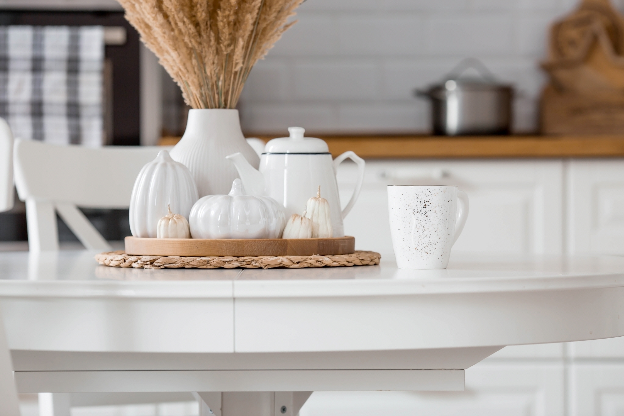 You can enhance a small white kitchen by adding antique elements such as porcelain plates, teacups, dried flowers.