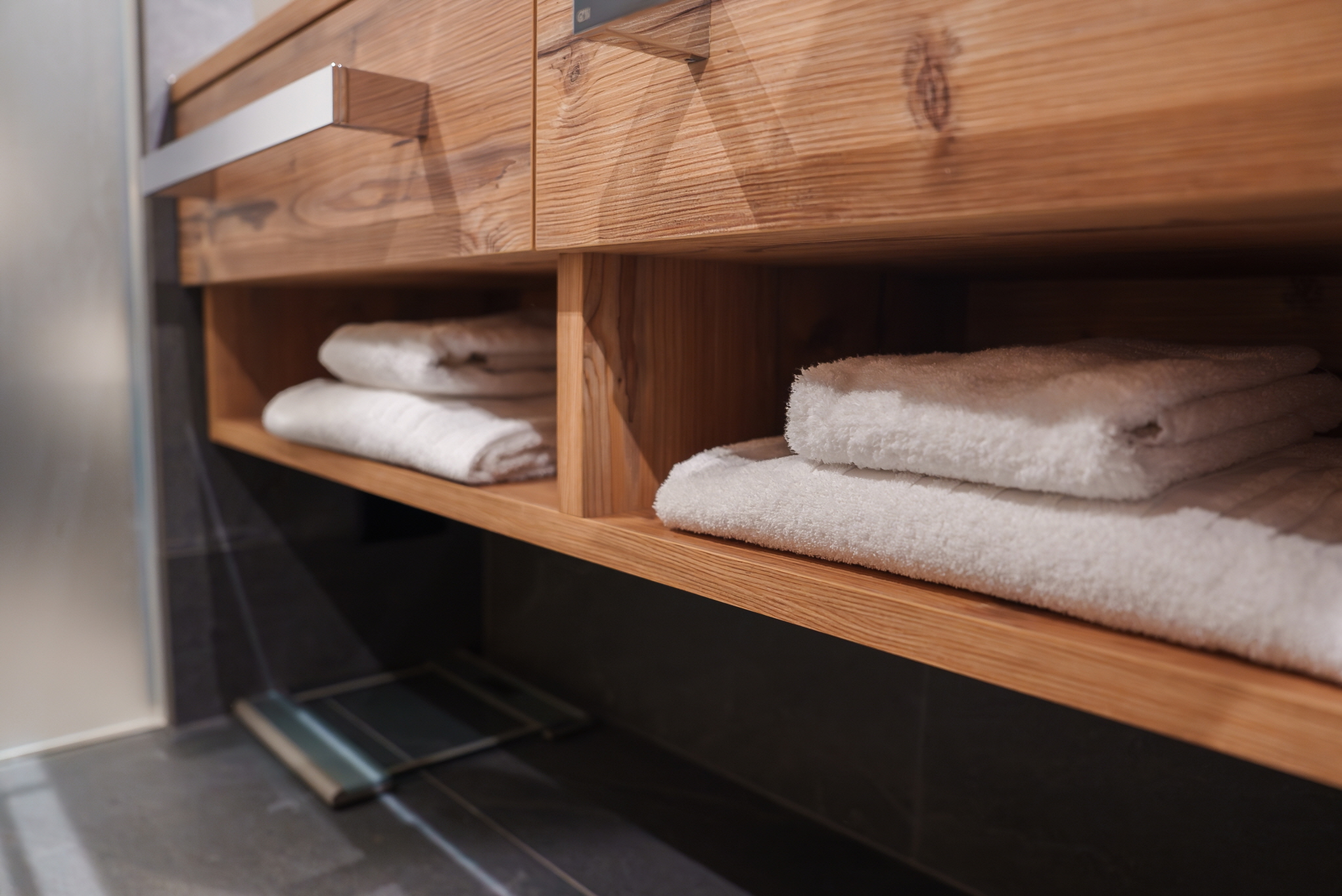 Combine practicality and design in your bathroom by utilizing an open-bottom vanity with exposed shelving.