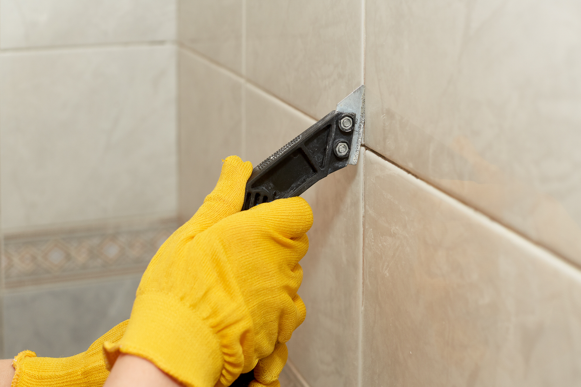 Grout removal involves carefully removing the grout between the tiles and cleaning away dust and debris.