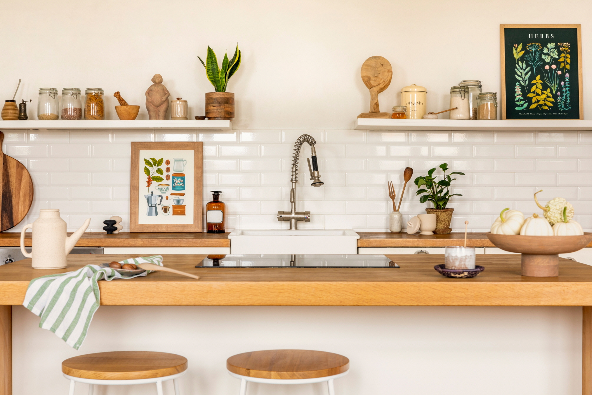 Artwork in the kitchen can fill unused space and contribute to a balanced kitchen design.