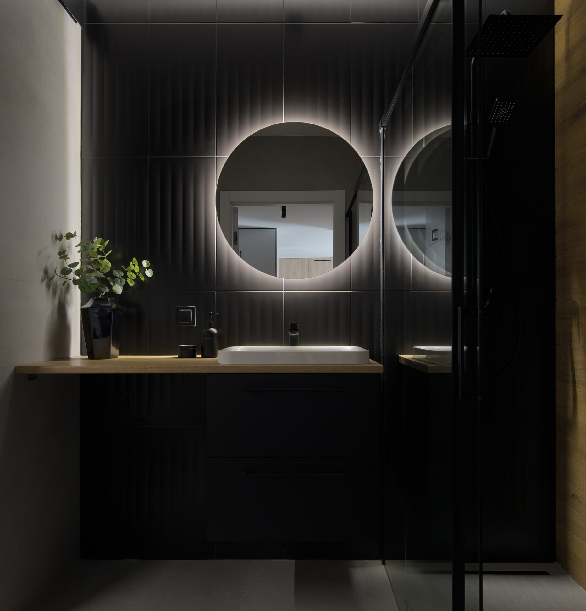 Dark walls, like black, create a sophisticated and dramatic powder room.