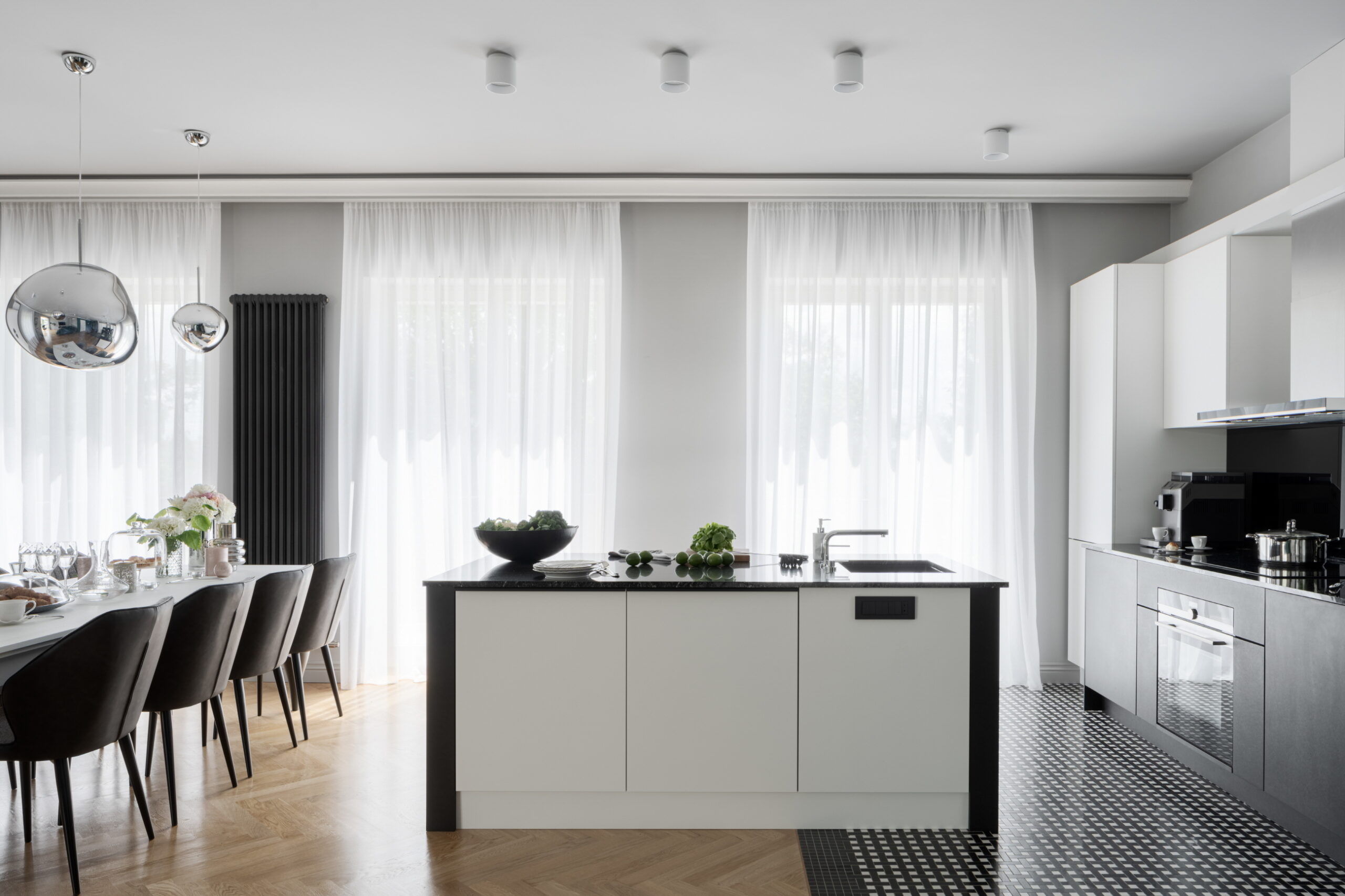 A monochrome kitchen design helps create a timeless, sleek, and clean atmosphere.