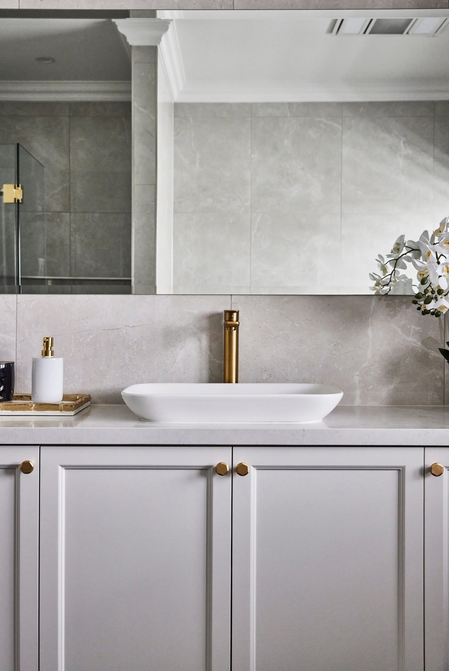 In bathrooms with limited space, consider utilizing a vanity with cabinets.