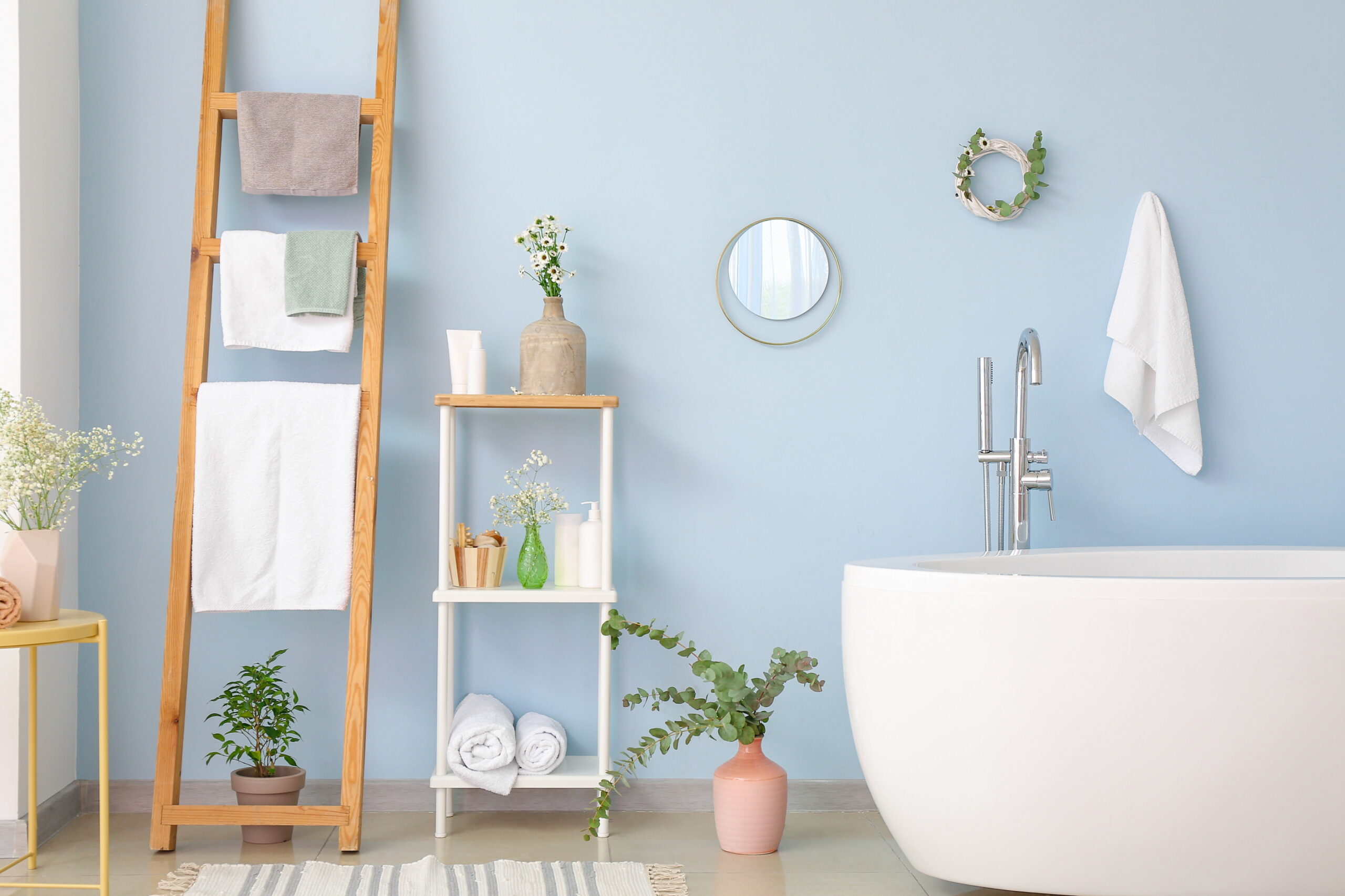 Use a vintage ladder to store towels in your bathroom, offering a creative and unique storage solution.