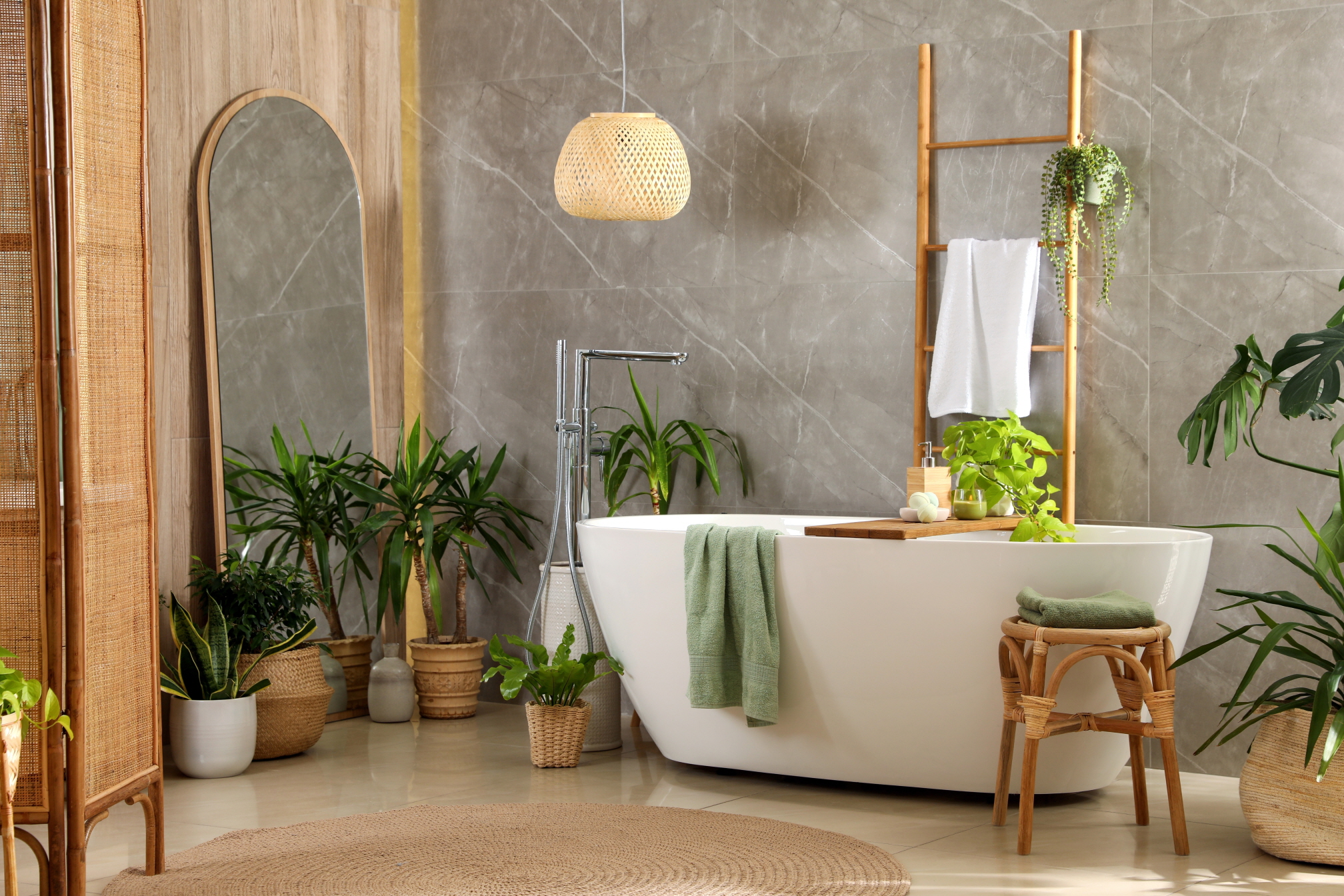 Transform your bathroom into a rainforest retreat with tropical botanical wallpaper and potted plants.