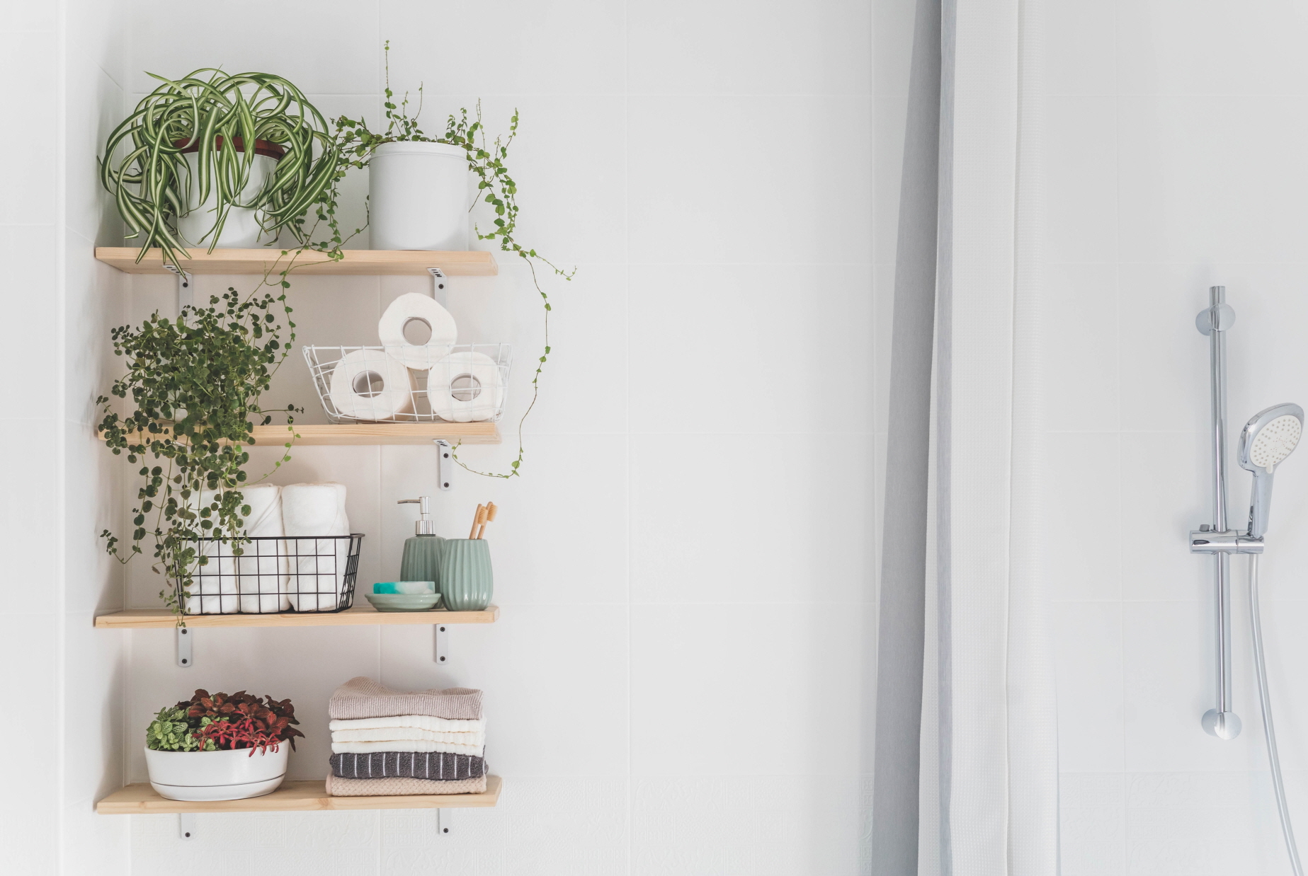 In small bathrooms, floating shelves can maximize the use of vertical wall space.