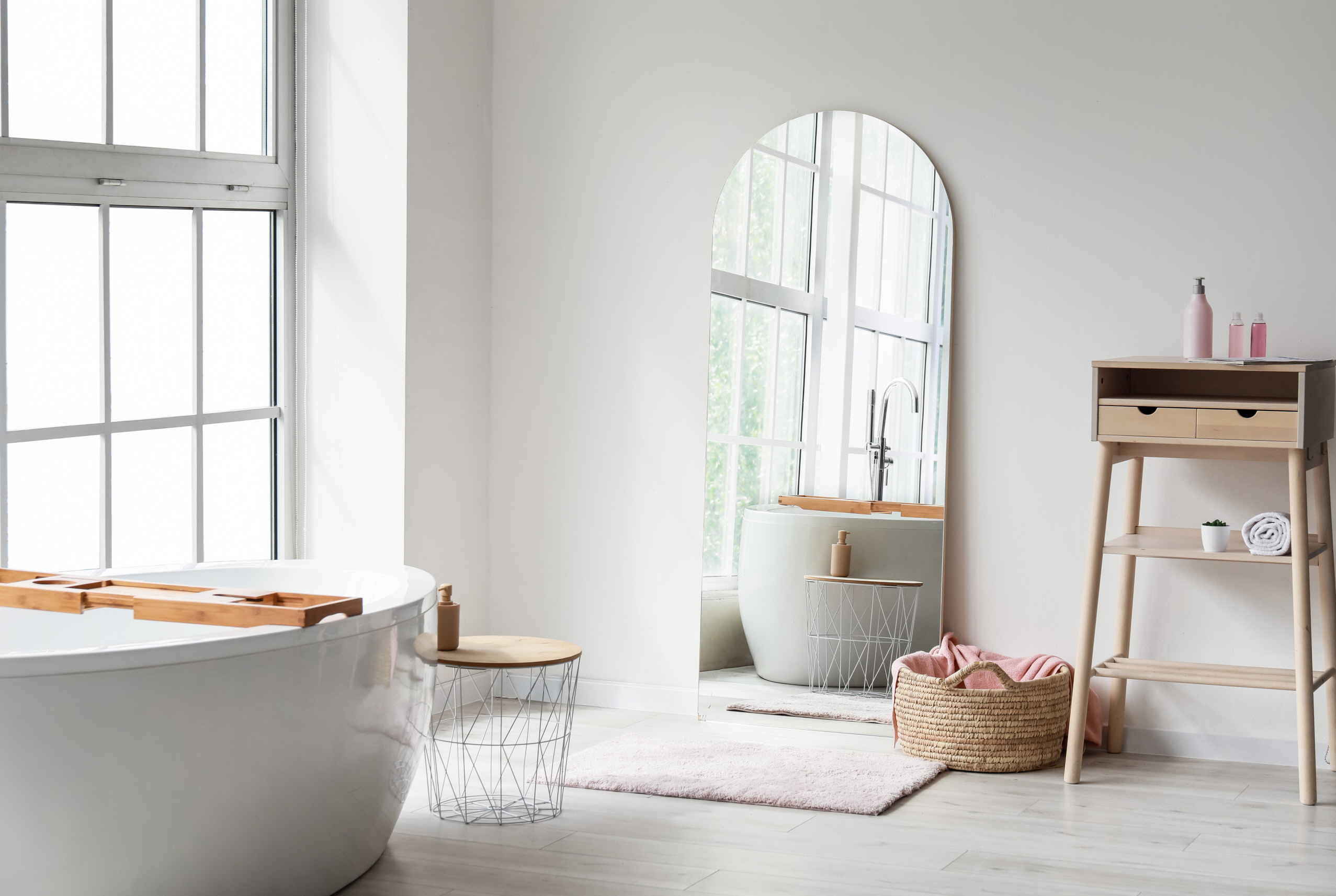 Place a large mirror across from a window to maximize natural light in a small bathroom, and replace a small vanity mirror with a wall-mounted mirror to make the space feel brighter and more spacious.