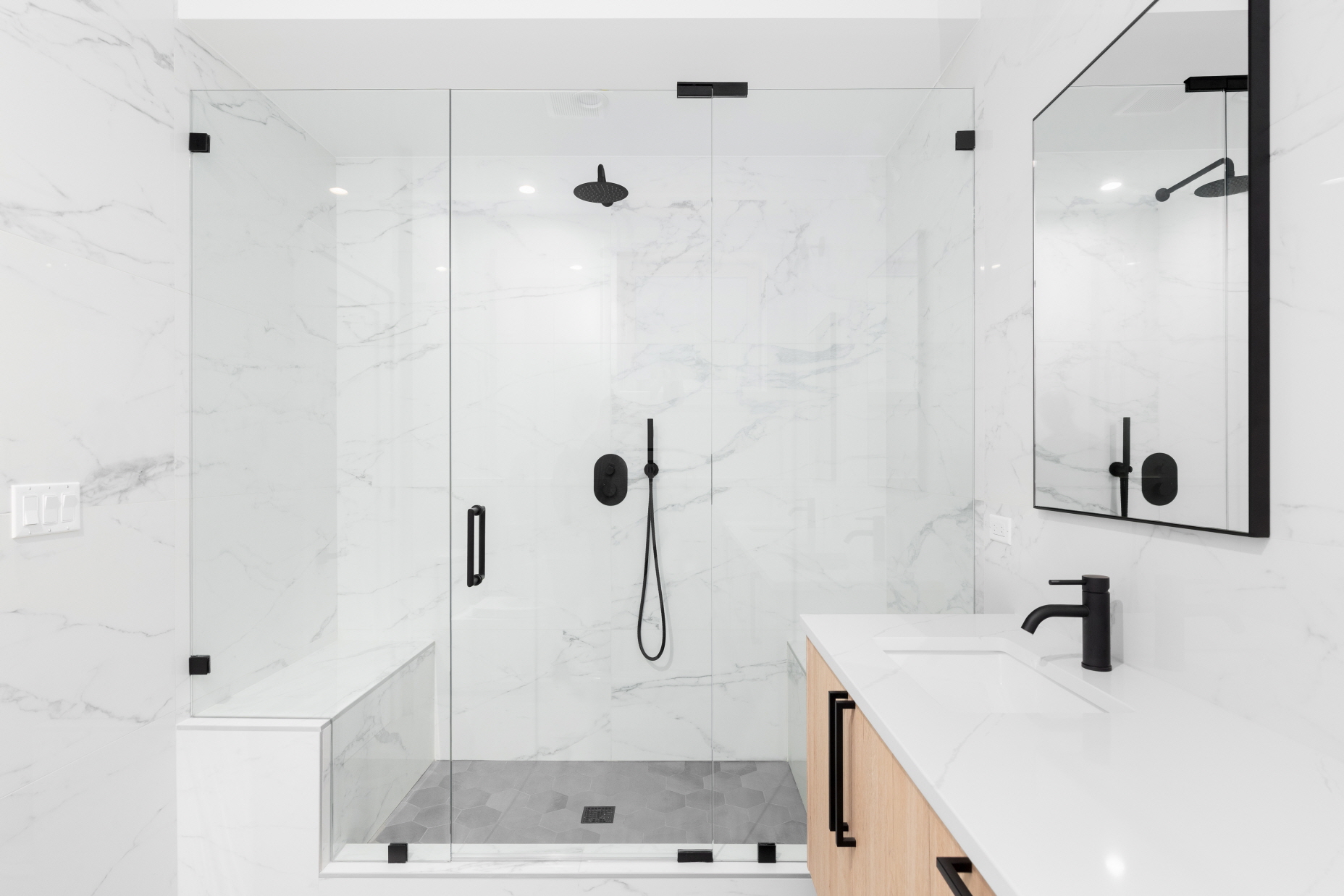 Clear glass shower doors eliminate visual barriers, contributing to a sleek, modern bathroom aesthetic.