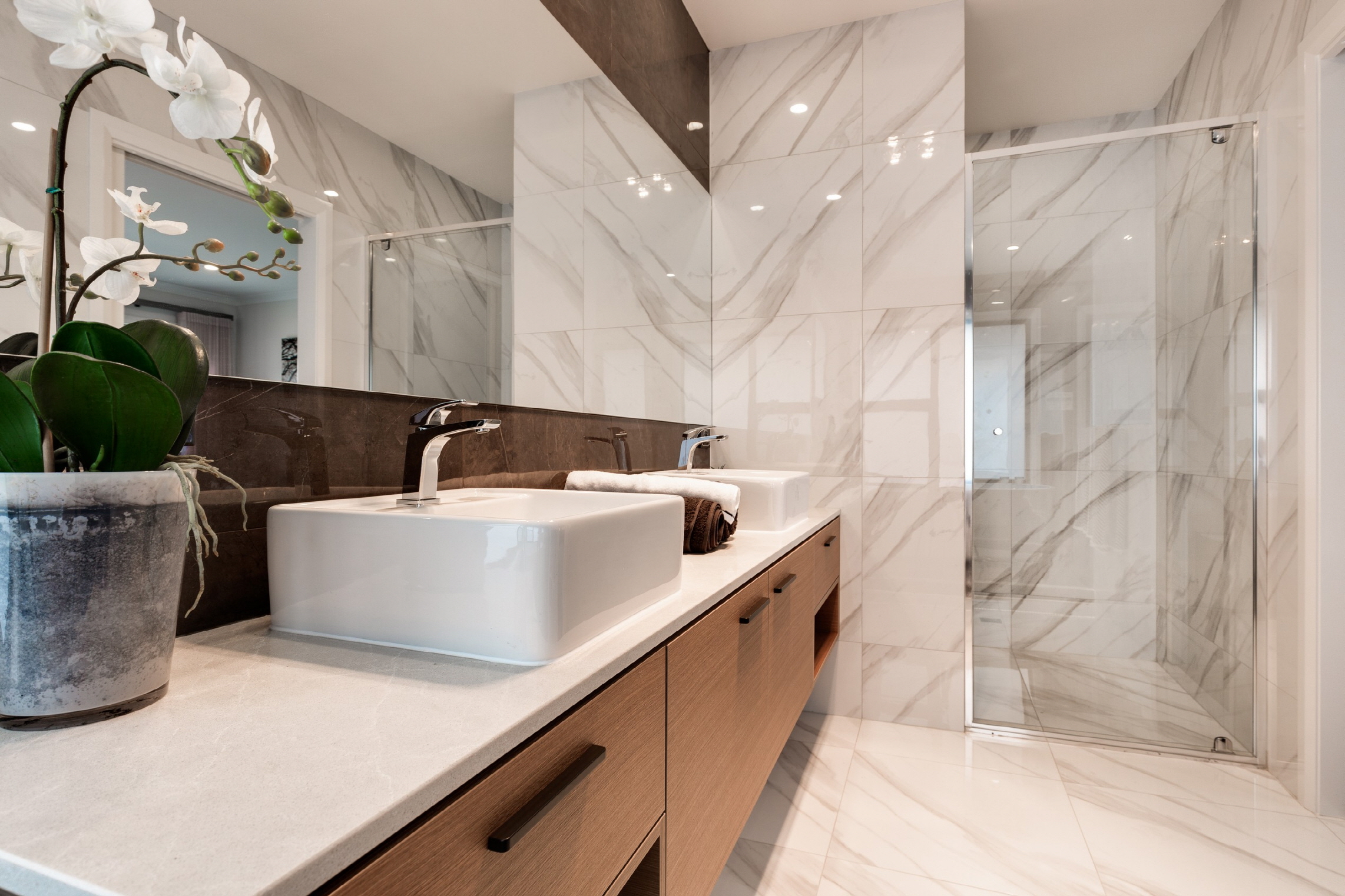 A smooth and glossy surface of the wall brings brightness to the bathroom.