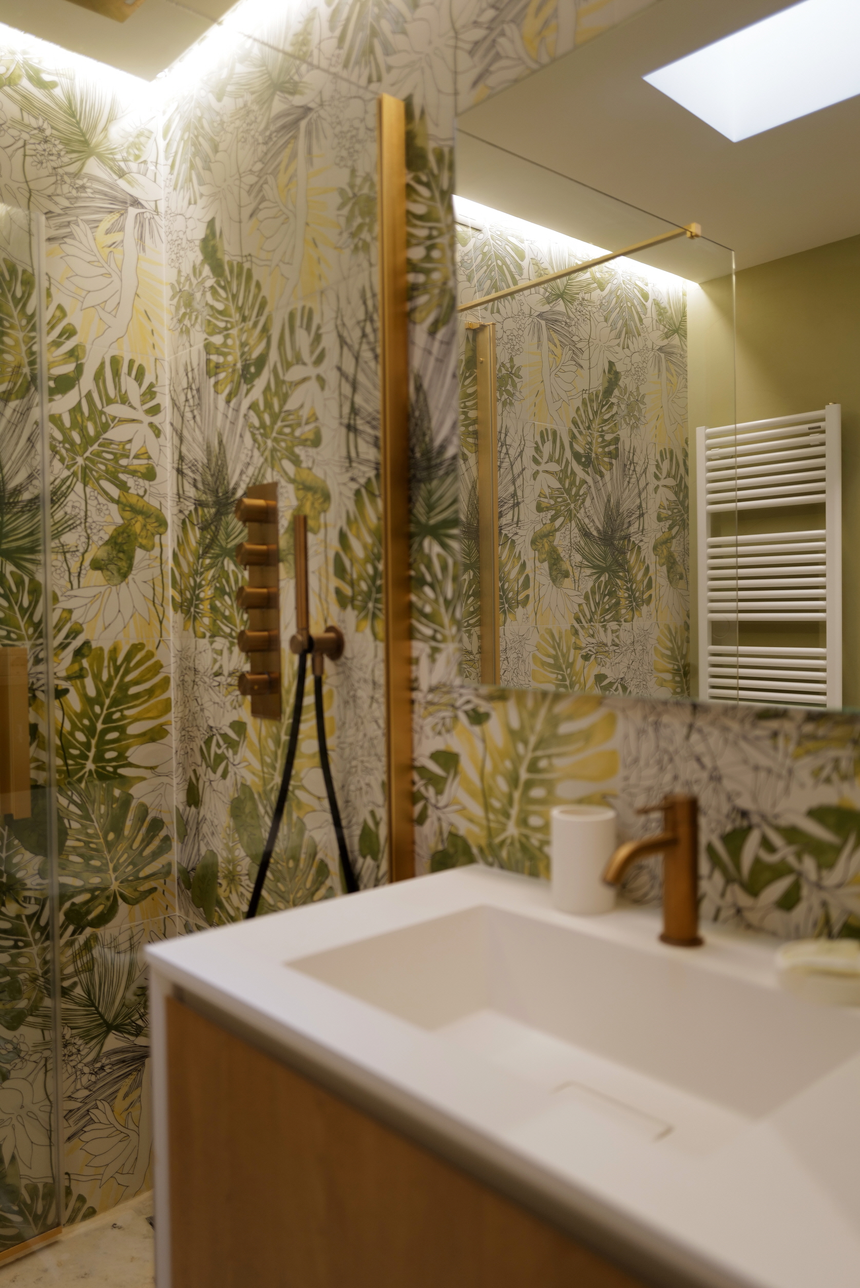 Transform your bathroom into a relaxing sanctuary by installing wallpaper featuring large, vibrant green leaves.