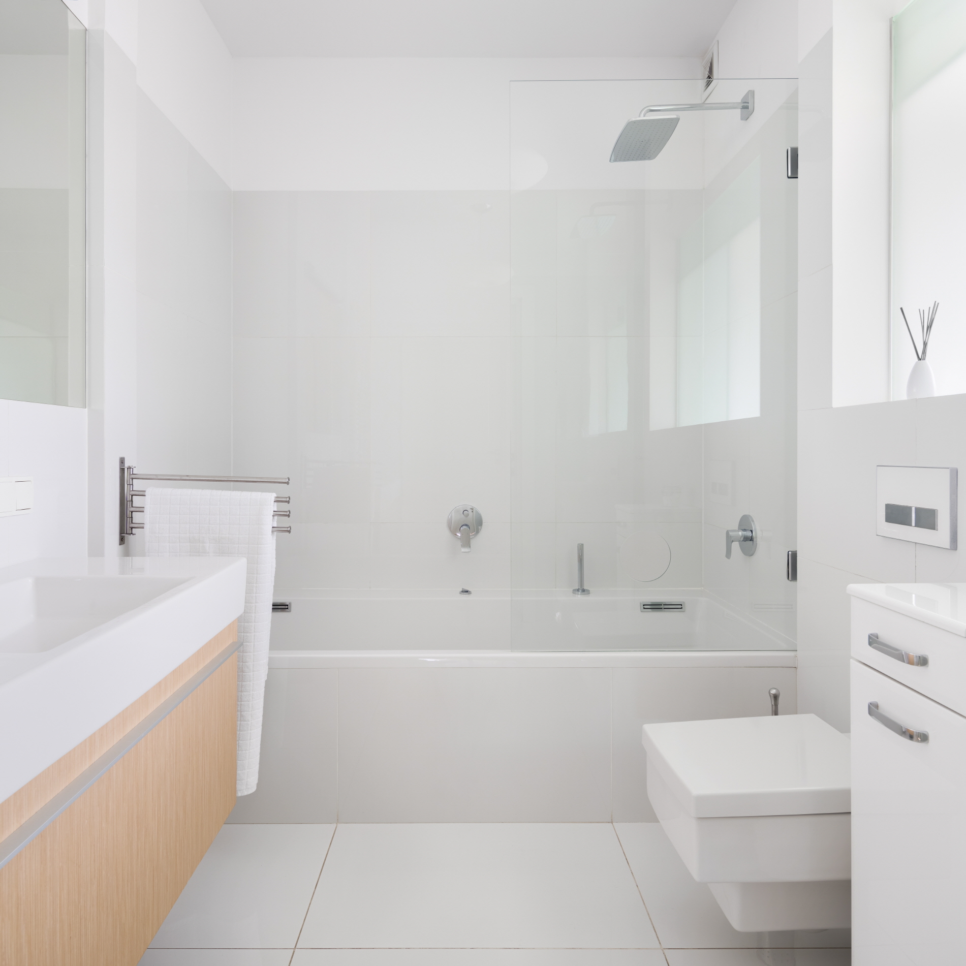 An all-white bathroom creates a bright, airy atmosphere that makes the space feel more spacious and inviting.