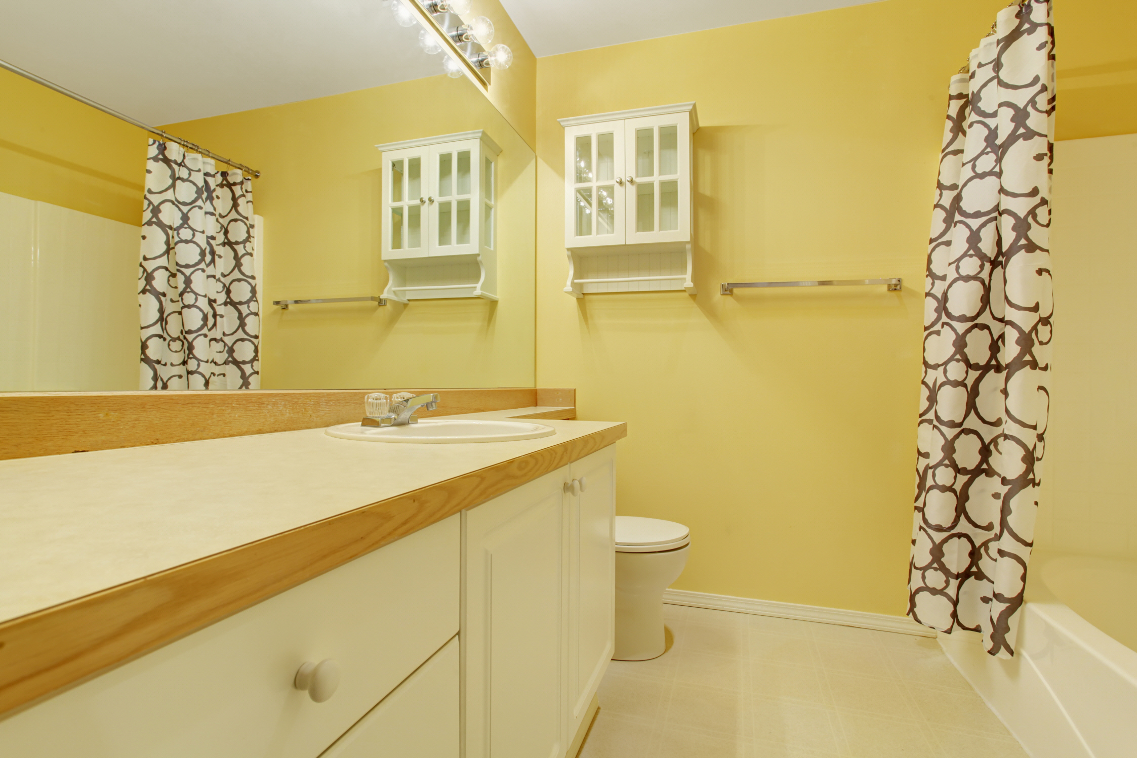 Sunny yellow infuses vibrancy and positivity into any space, making it a delightful choice for a guest bathroom.