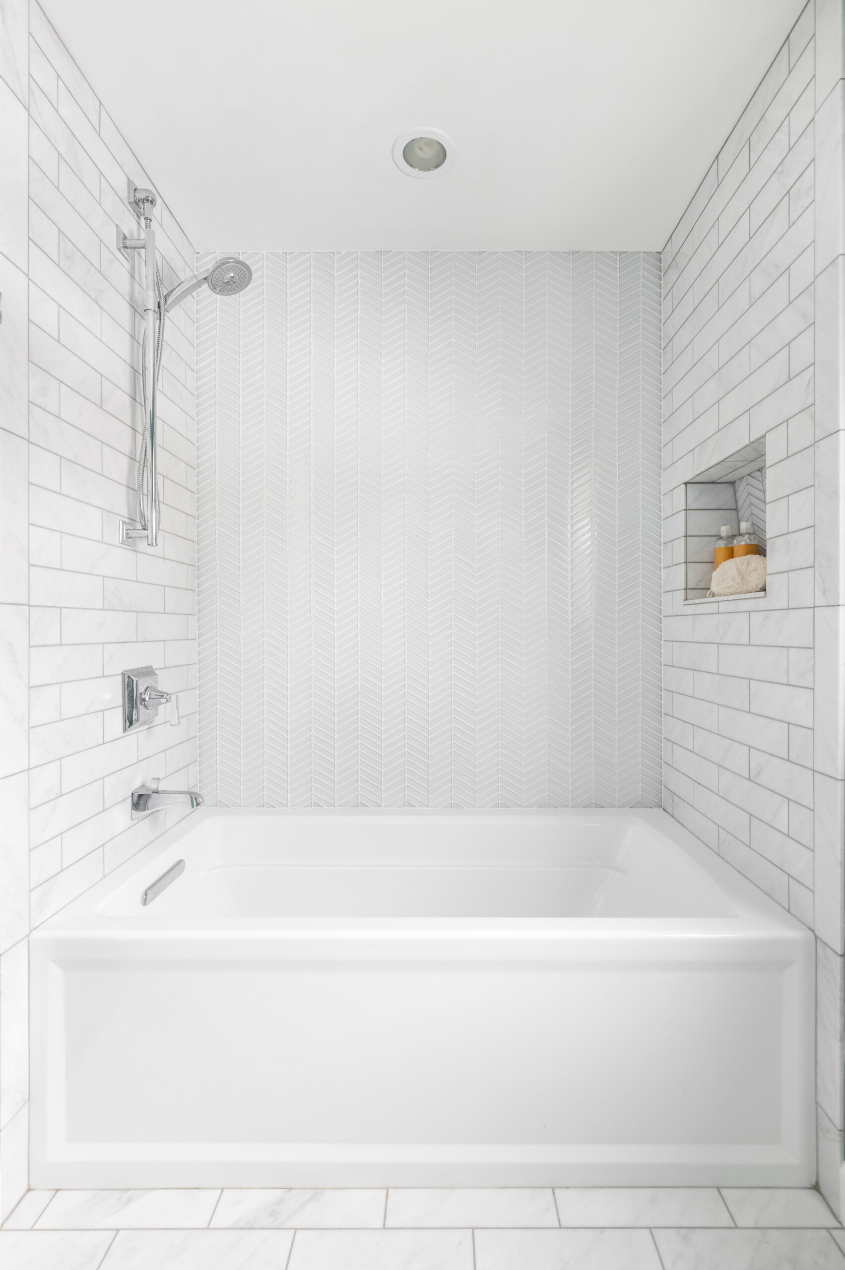 Seamlessly integrating a shower and bath is a space-saving design choice.