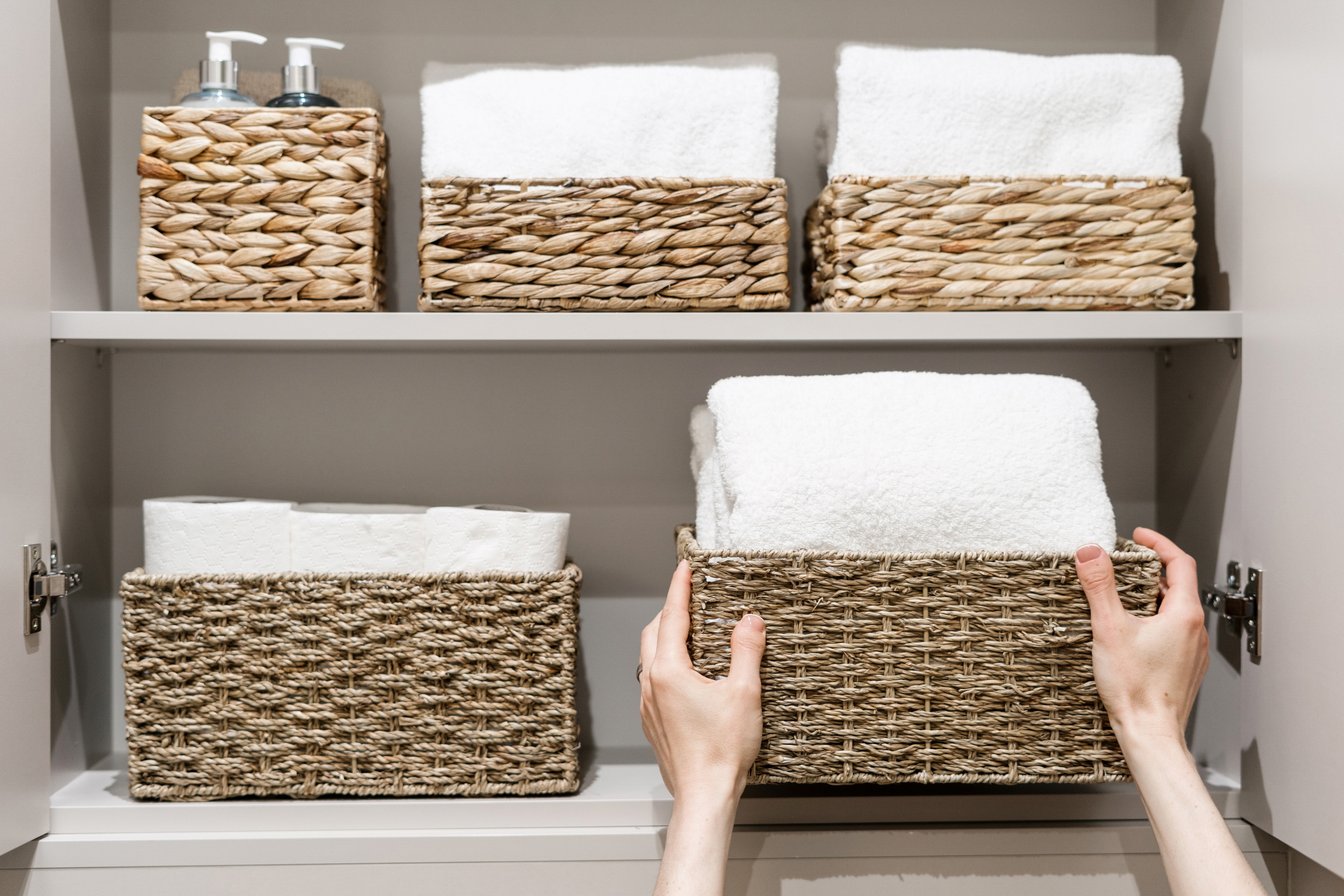 Organize your towels in a basket to keep your bathroom neat and inviting.