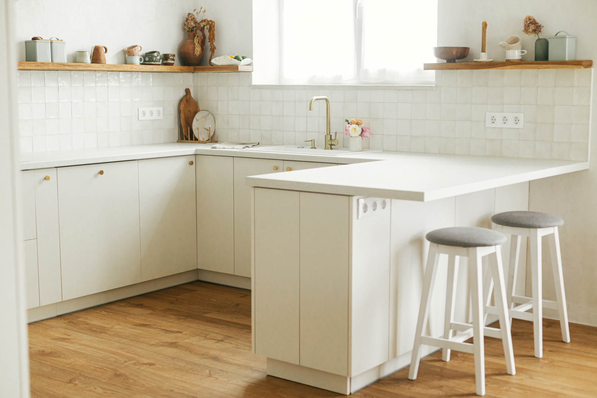 The U-shaped kitchen features three walls of cabinets and counters that form a U-shape, providing efficient use of the space.