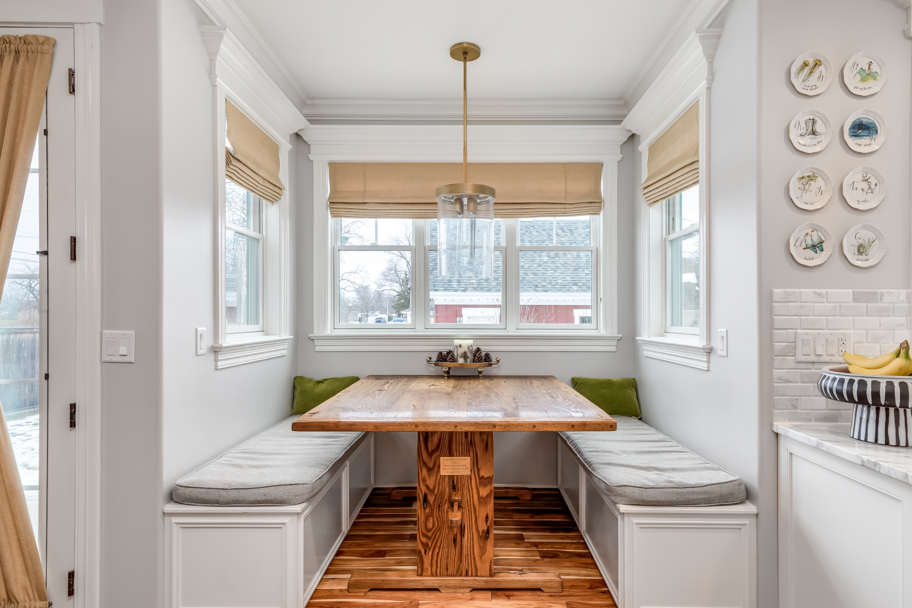 Add a corner banquette to create a warm and cozy dining area in the corner of a small kitchen.