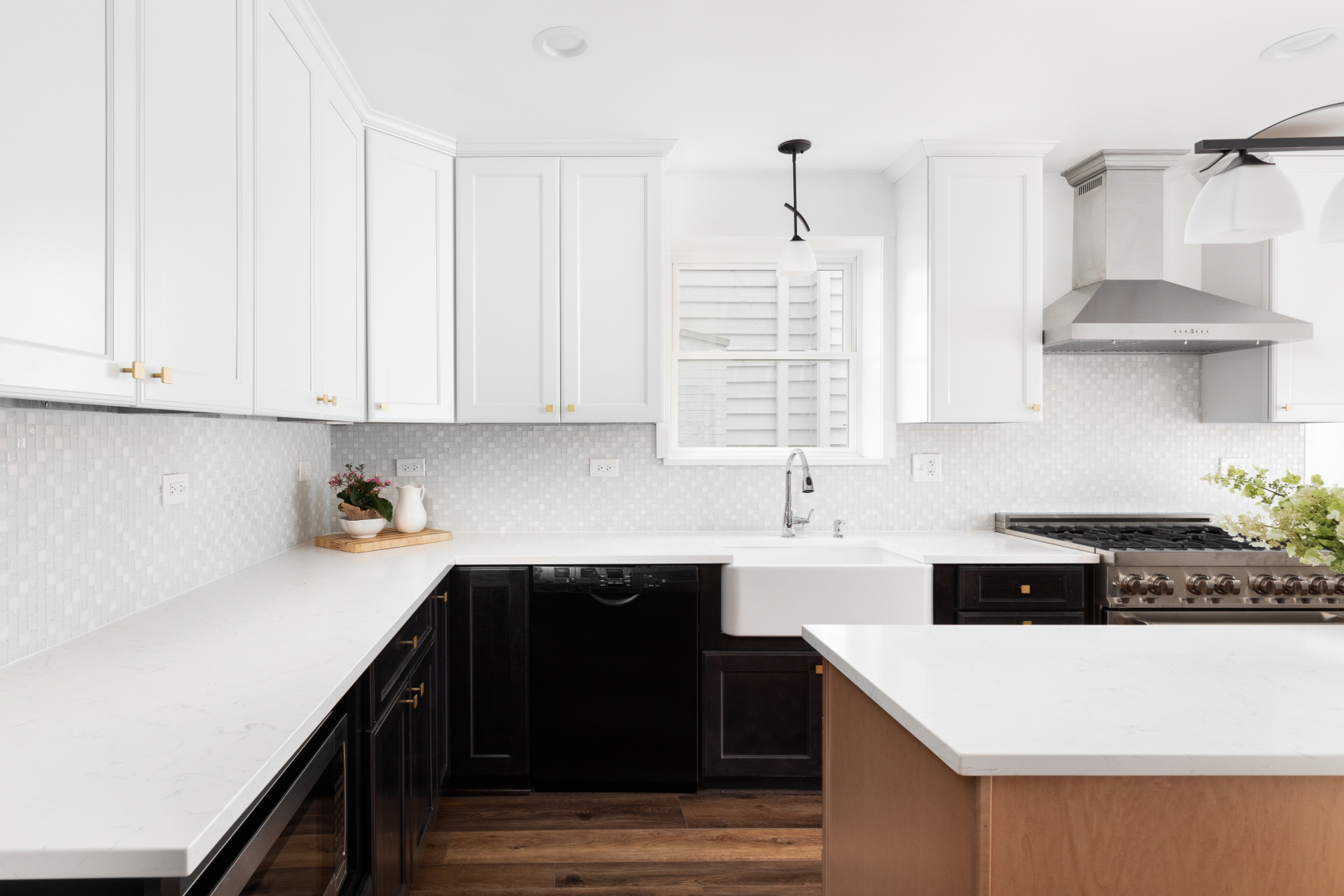 The L-shaped kitchen has two connected walls lined with counters and cabinets, minimizing the use of floor area.