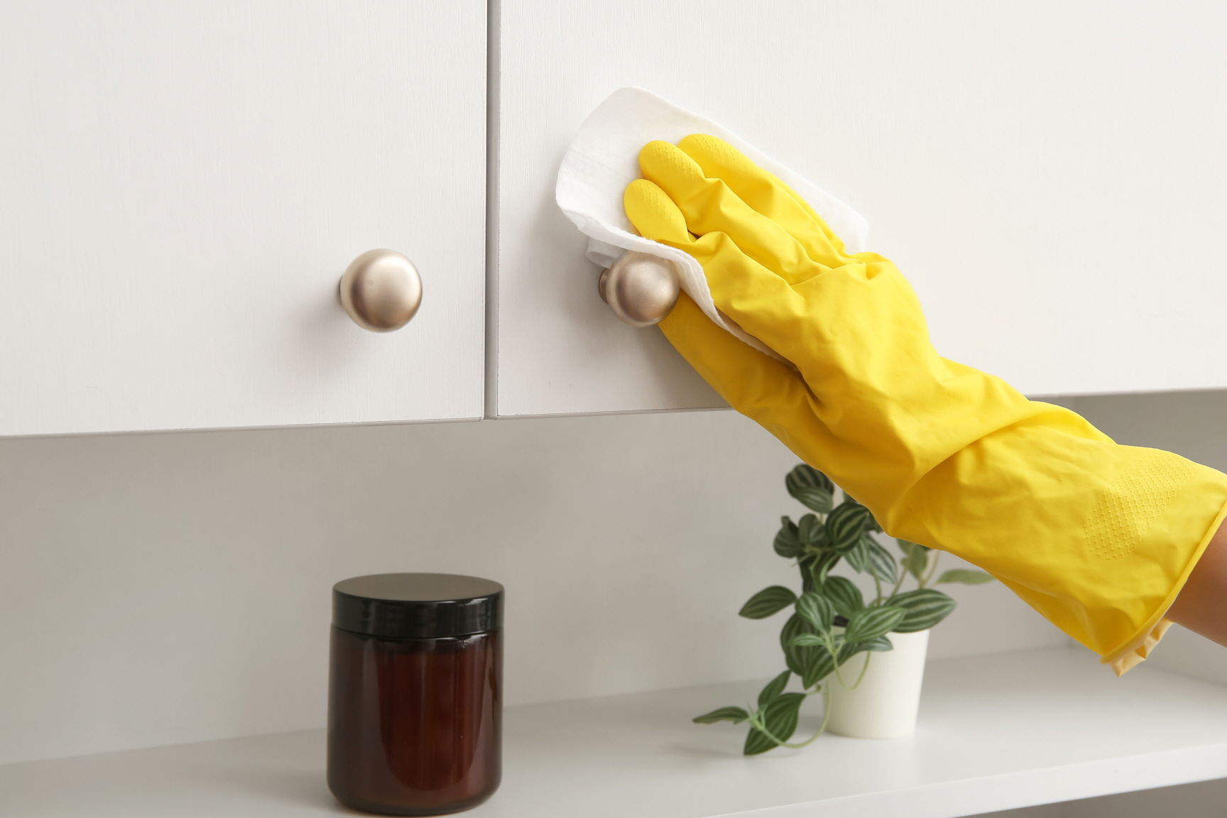 Wear gloves to protect your hands and safely clean the cabinet doors.