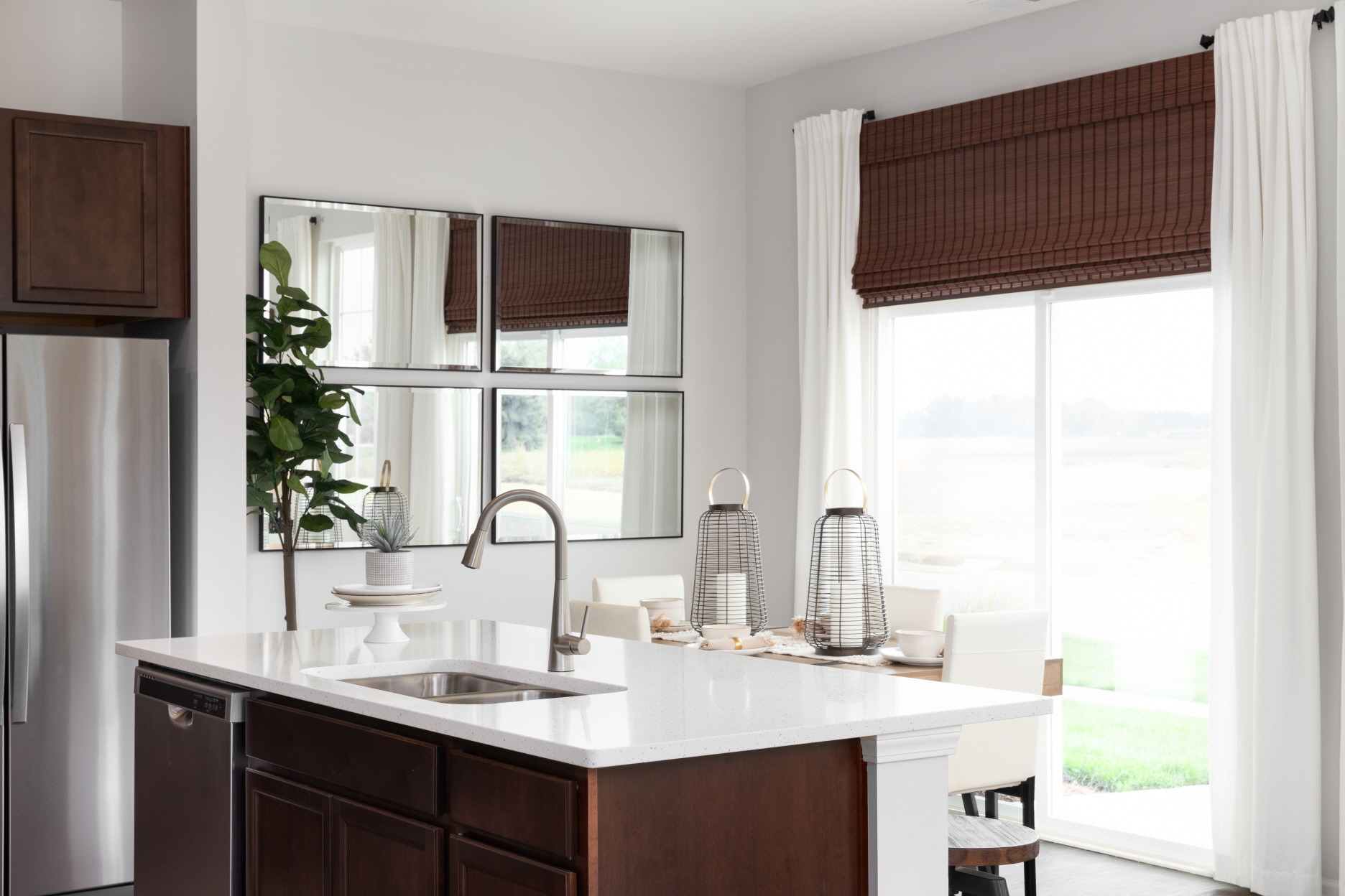 Placing mirrors on an empty wall can reflect light throughout the room, illuminating the kitchen space.