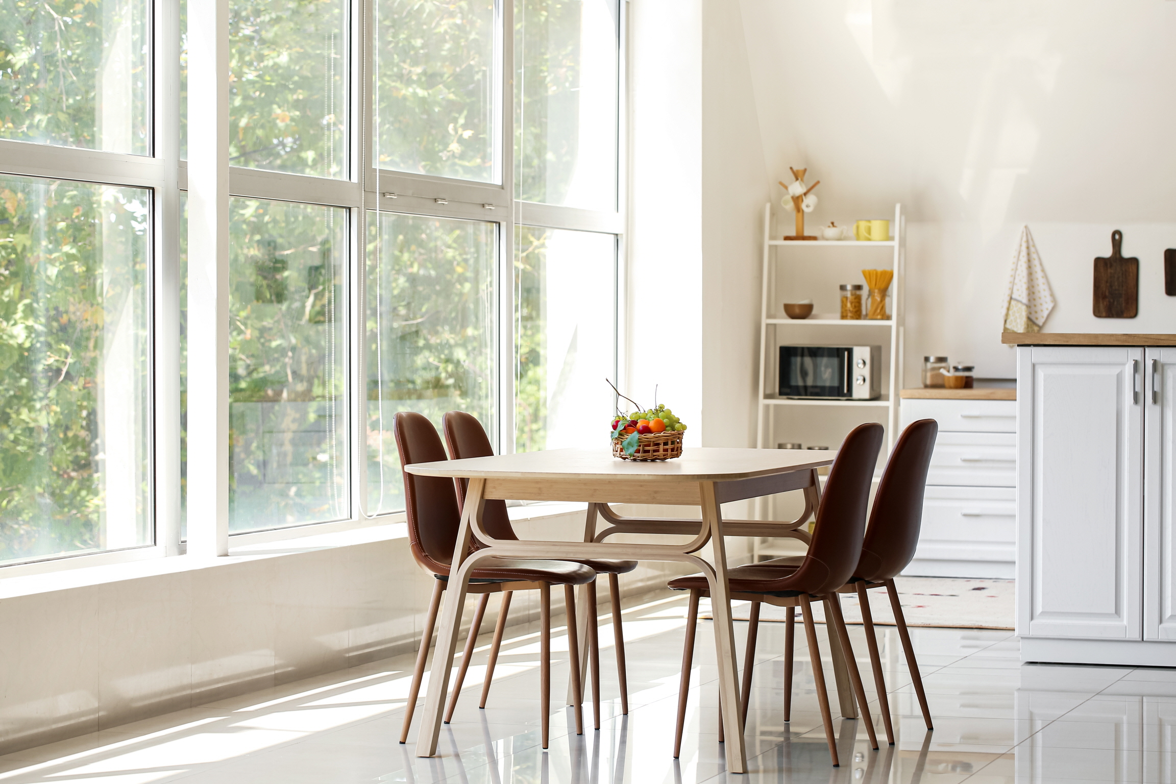 Install large windows in your kitchen to increase natural light and create a cozy dining space.