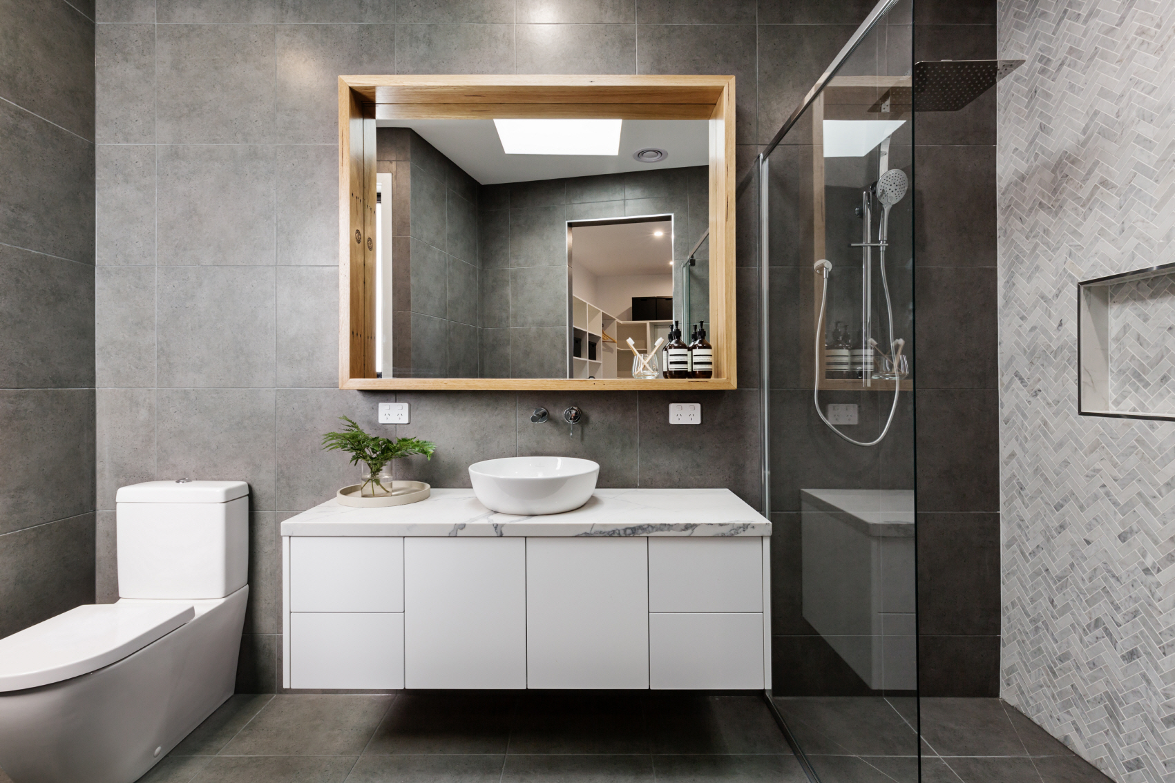 Consider using a charcoal color for a modern and sophisticated guest bathroom.