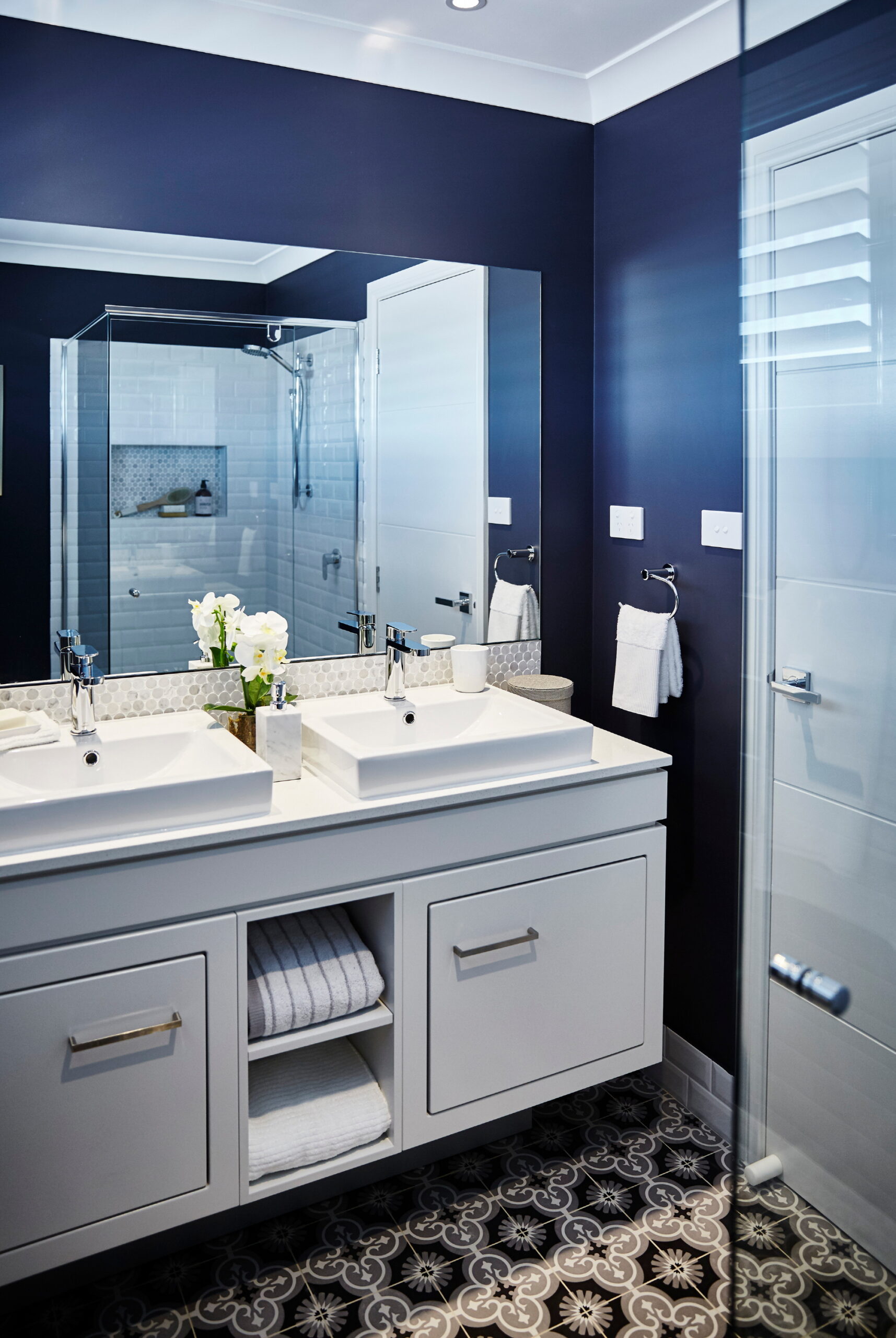 The deep navy color brings timeless elegance, perfectly complementing a modern bathroom.