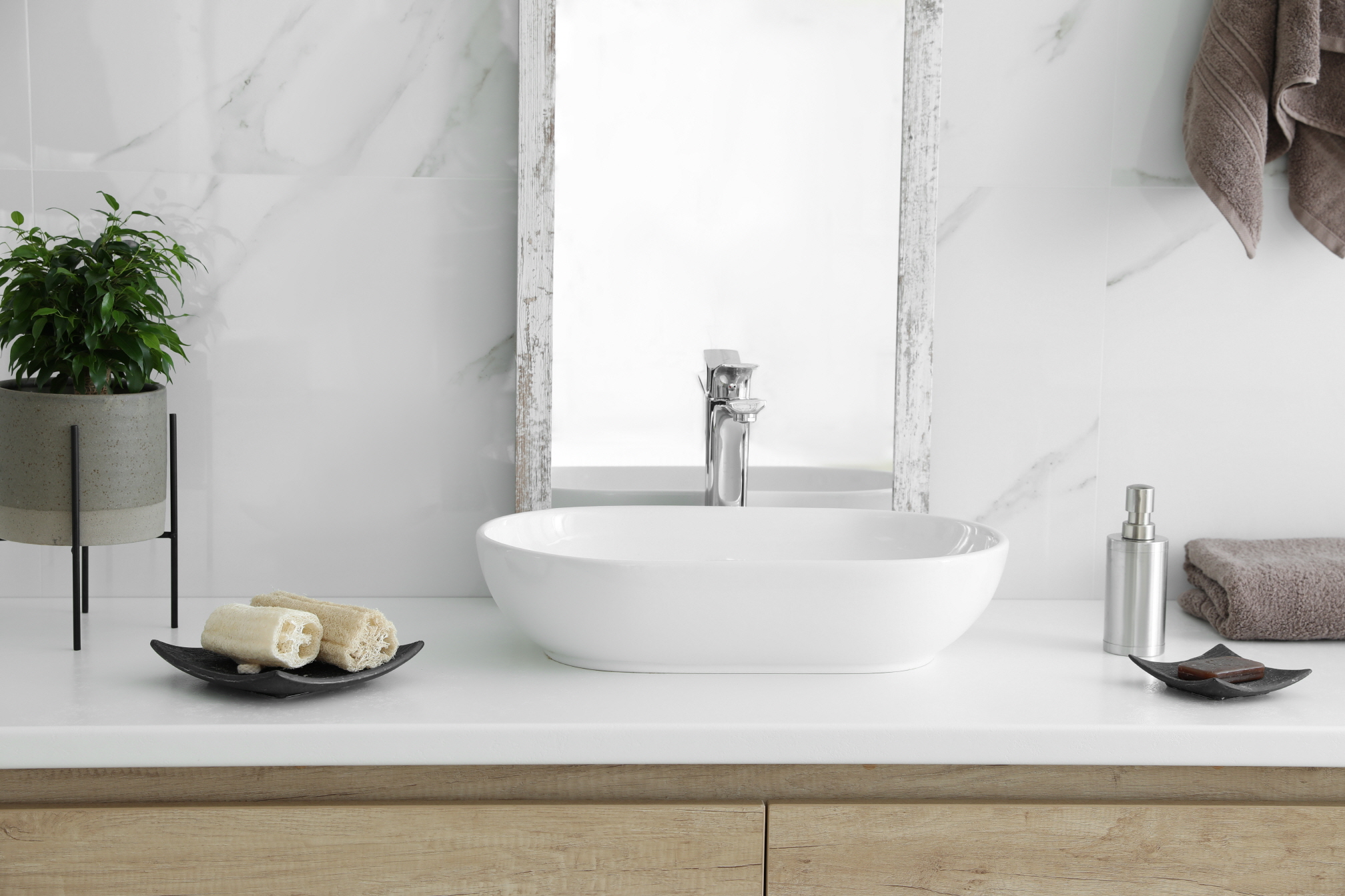 To create a minimalist bathroom environment, focus on high-quality essentials that make an impact without overcrowding the space with decor.