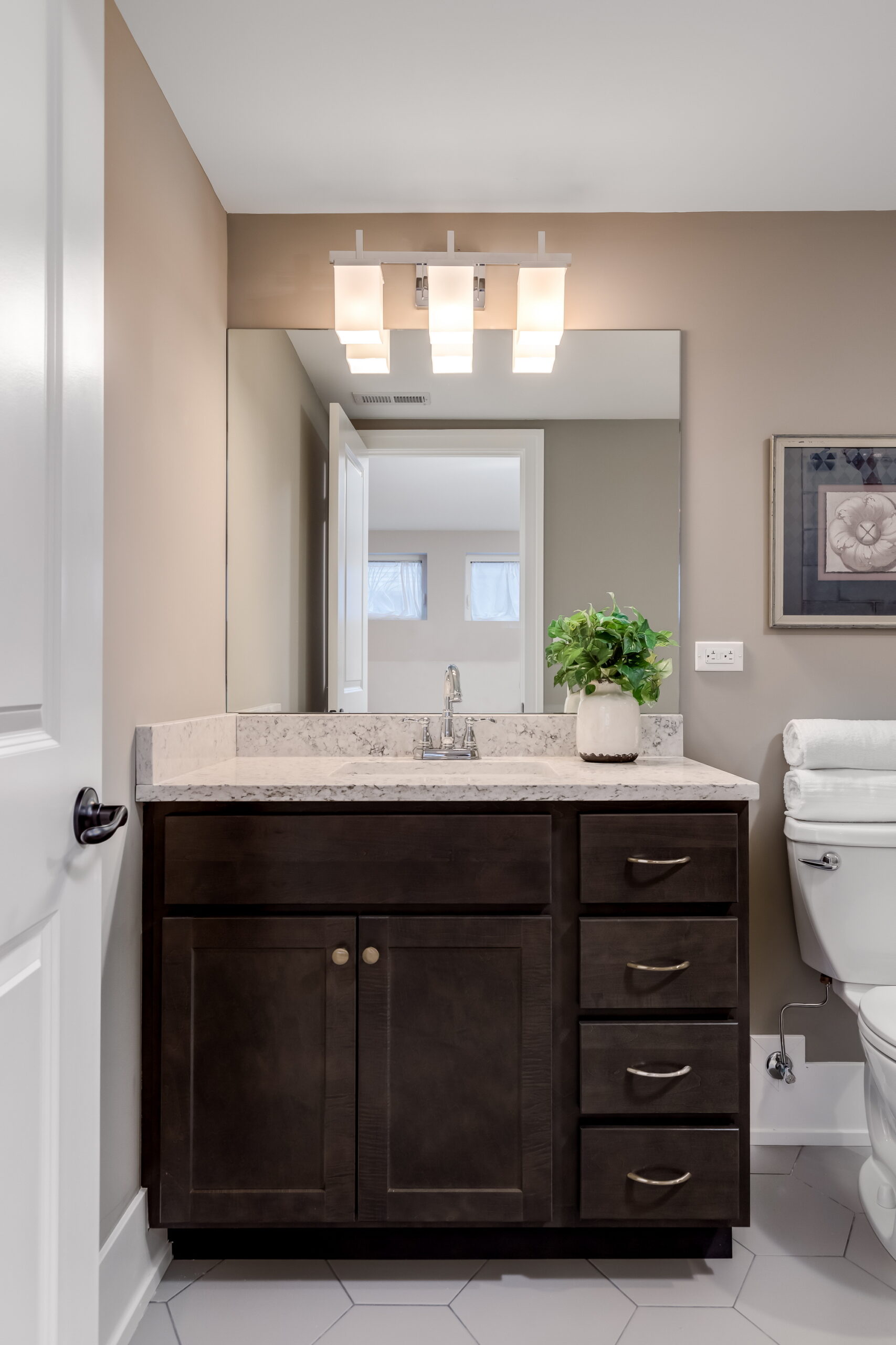 A half bathroom, also known as a "powder room," is a compact yet functional space ideal for accommodating guests.