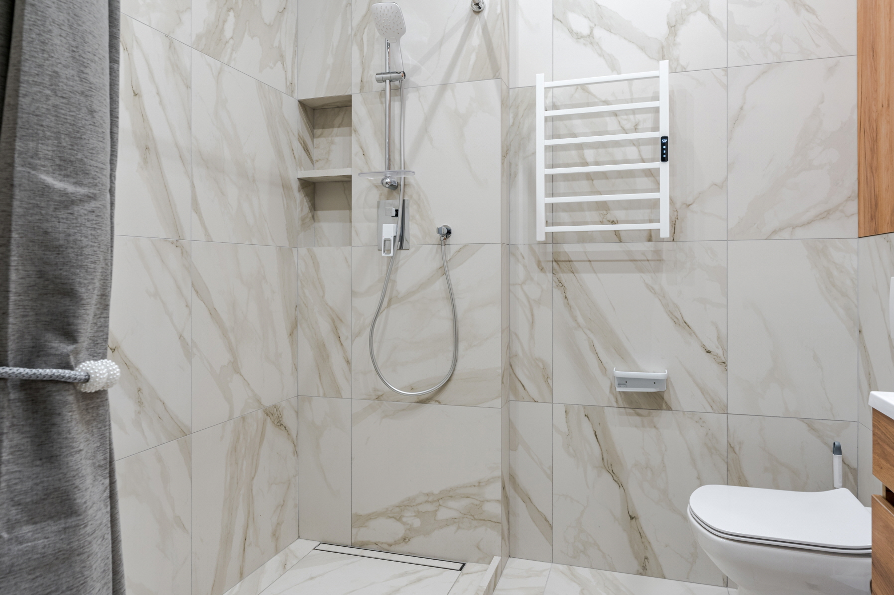 To create an open bathroom, consider a doorless walk-in shower as an alternative to a bathtub.