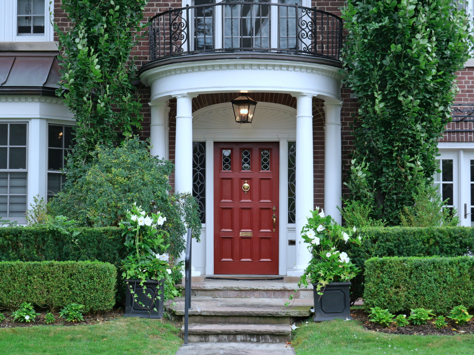 Add stylish lighting to your portico to create a warm welcome for your guests.