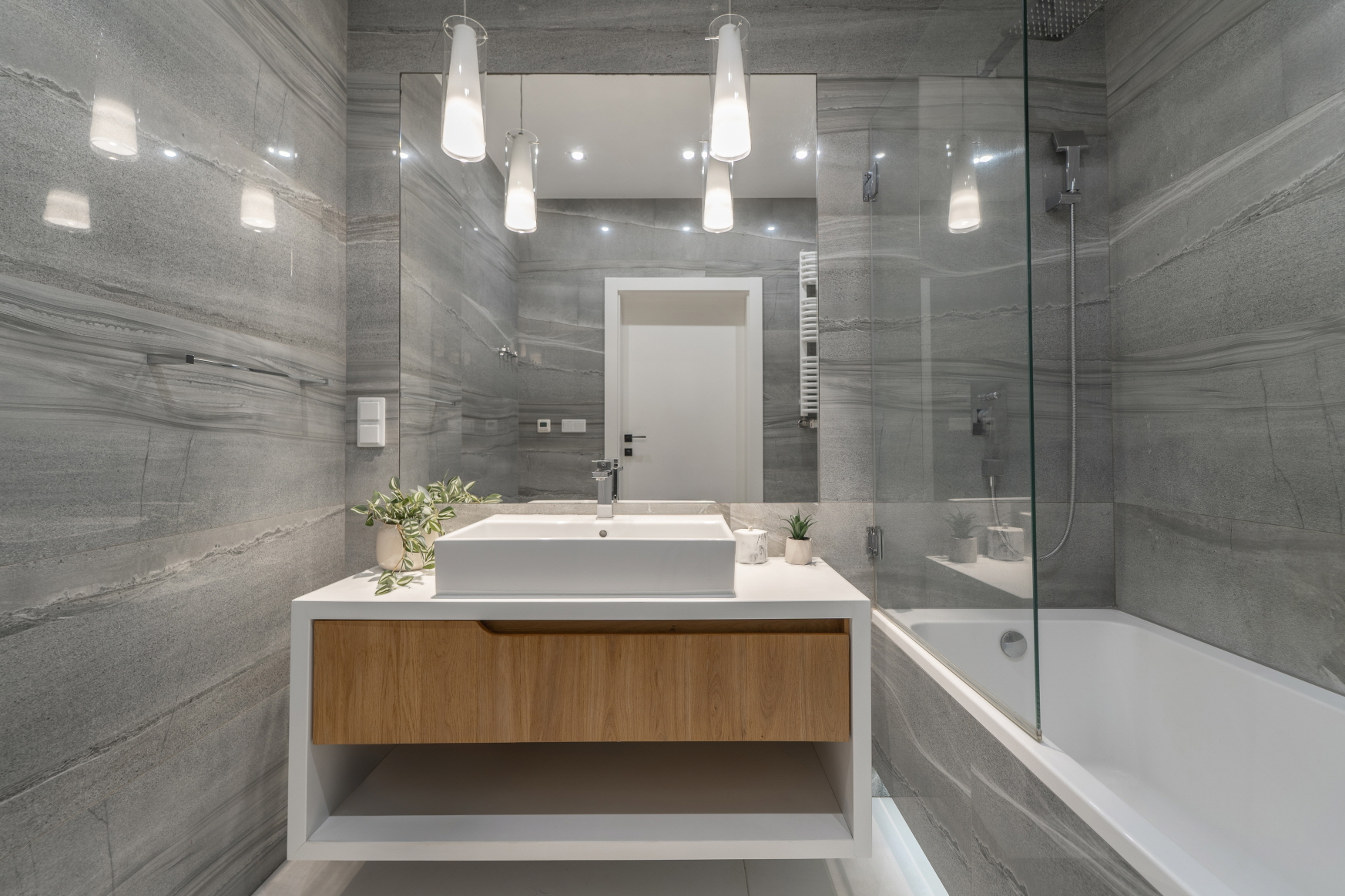 Lighting plays a vital role in brightening the bathroom space while also serving as a design element.