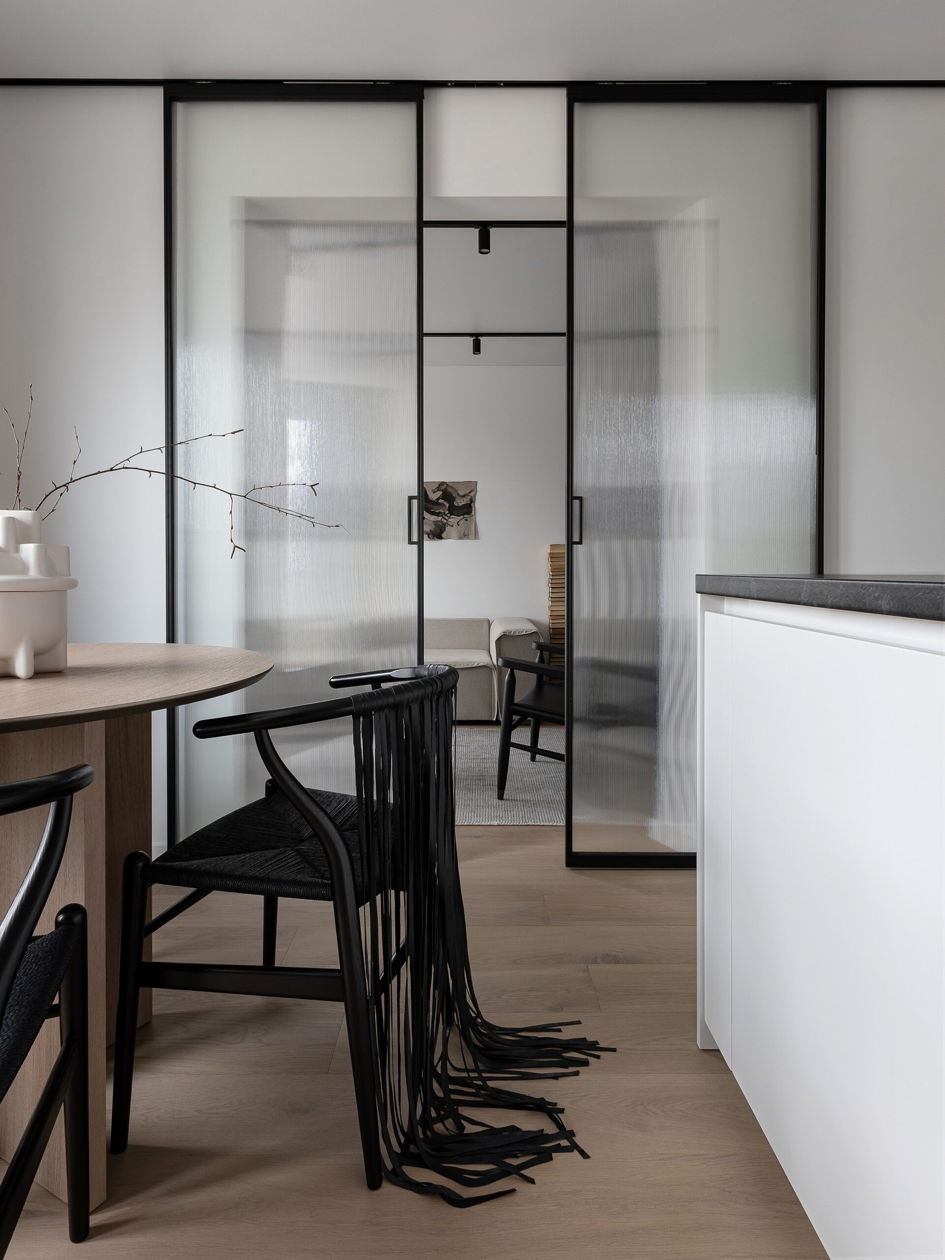 Install a transparent partition in your open kitchen to allow light to pass through while maintaining separation between the kitchen and other spaces.