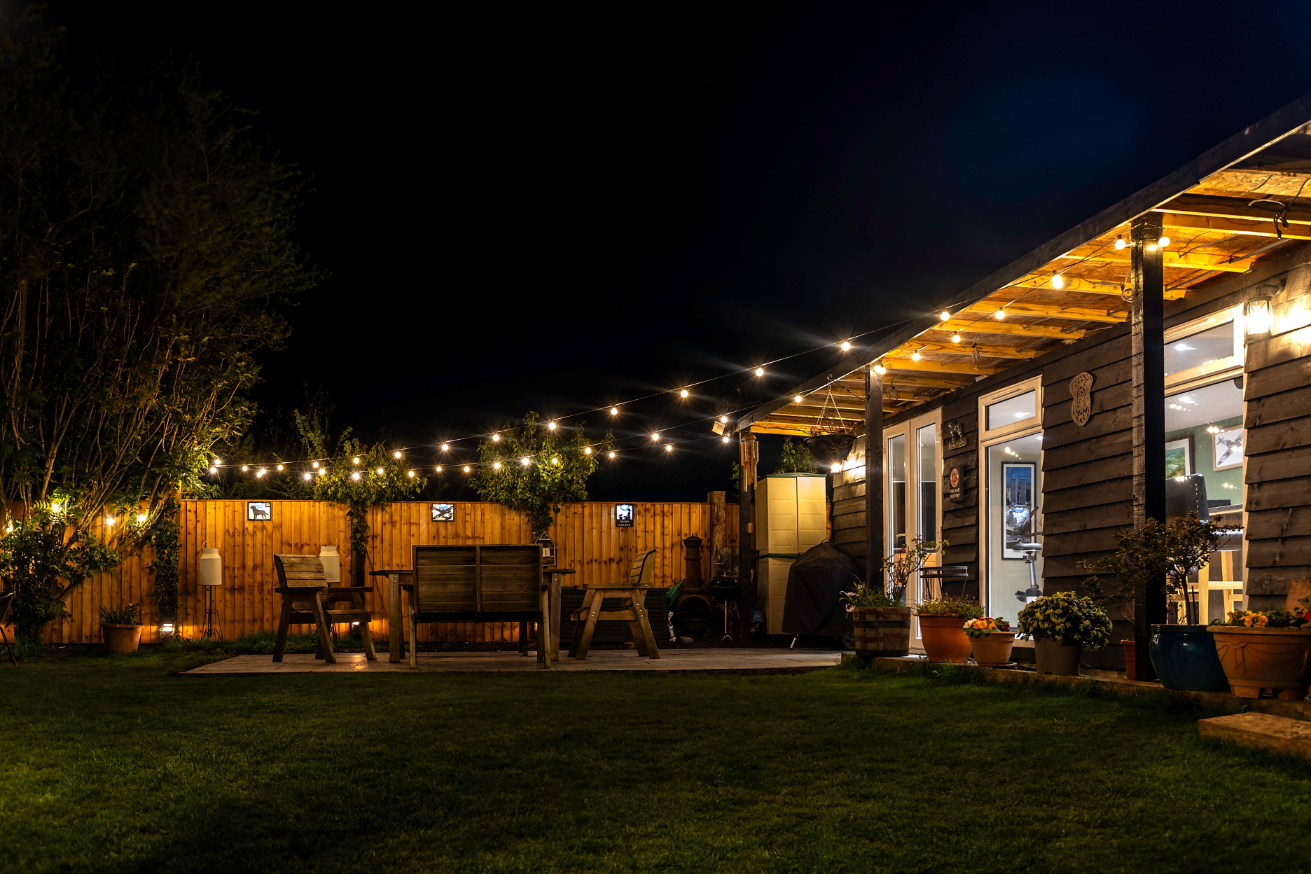 Transform your patio into an extension of your living room with warm lighting.