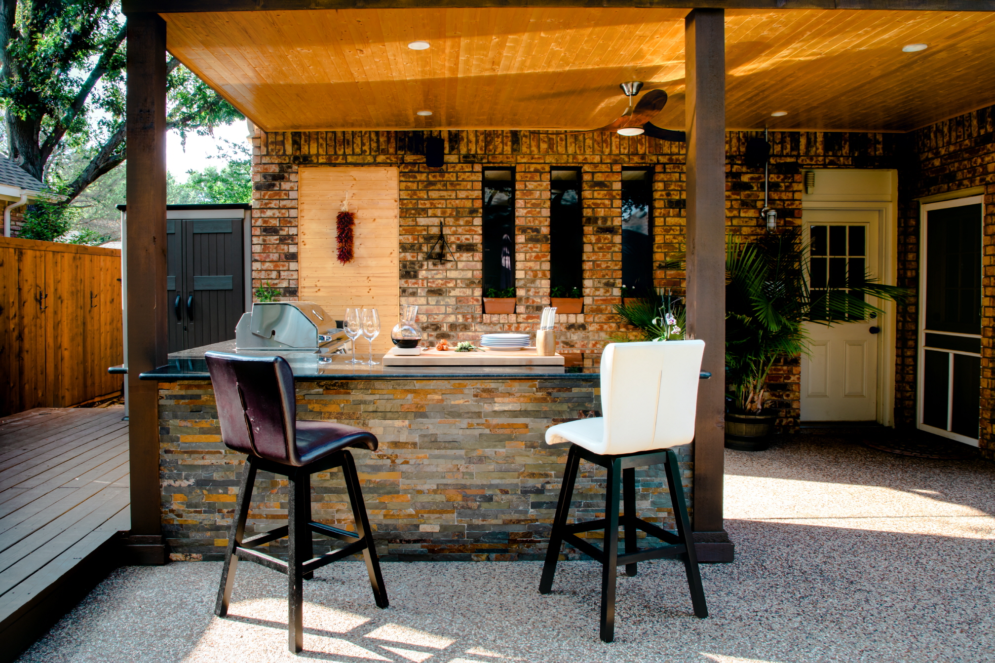 Placing an outdoor kitchen close to the house offers easy access to indoor amenities and is a cost-effective solution, as it lowers the expense of extending utility lines.